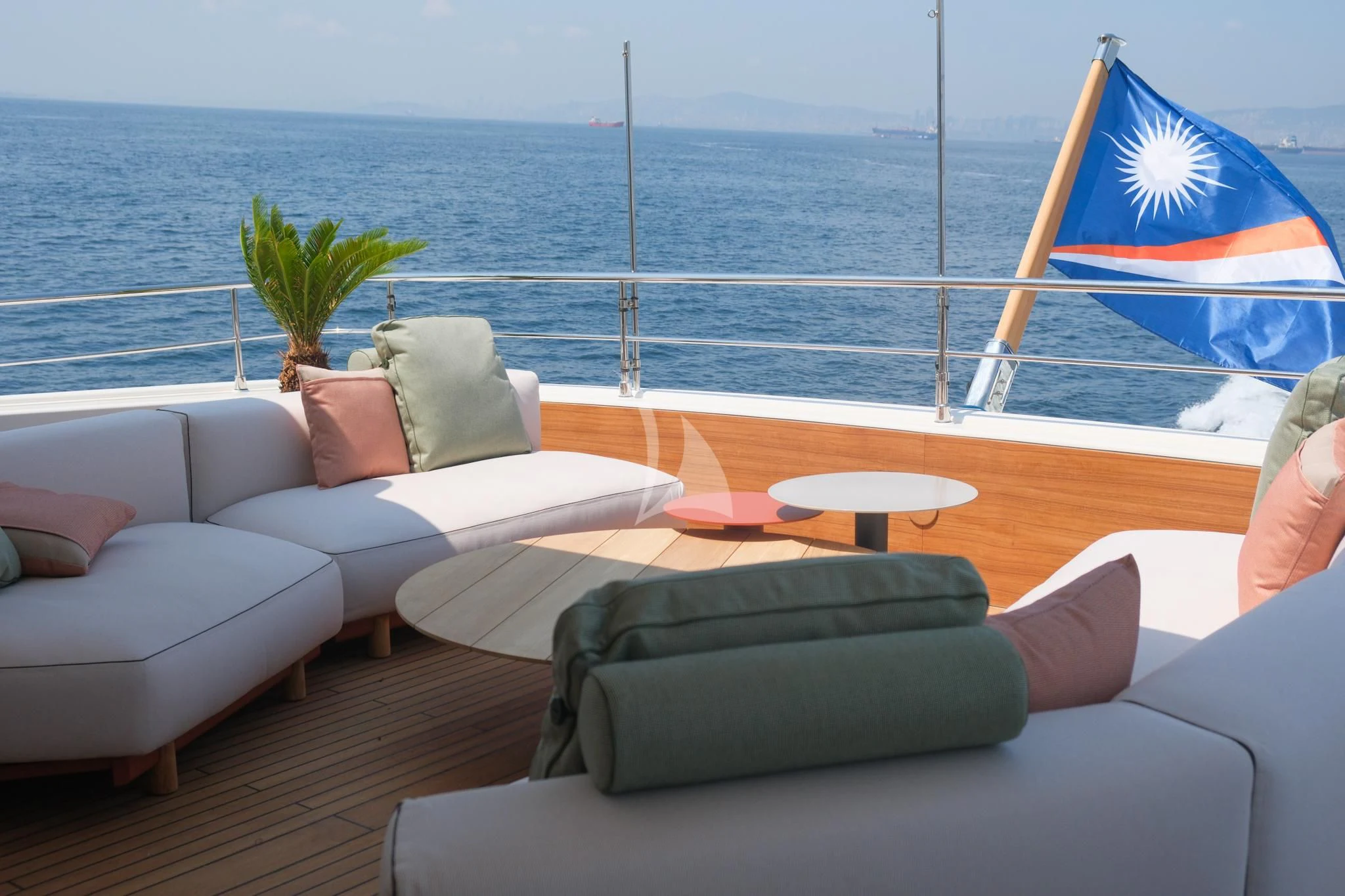a boat with a flag on the deck aboard AERO Yacht for Charter