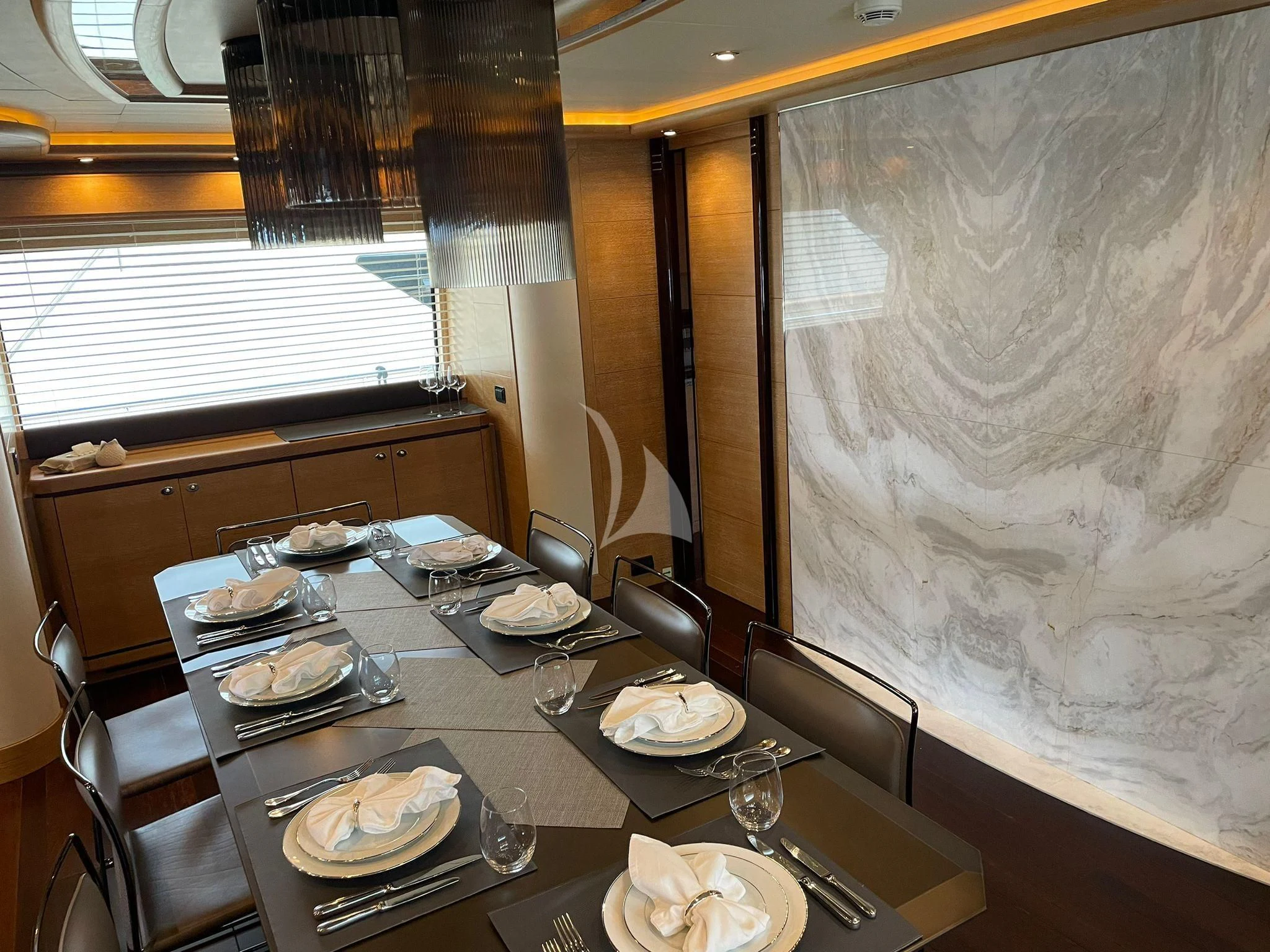 a dining table with plates and silverware aboard AERO Yacht for Charter