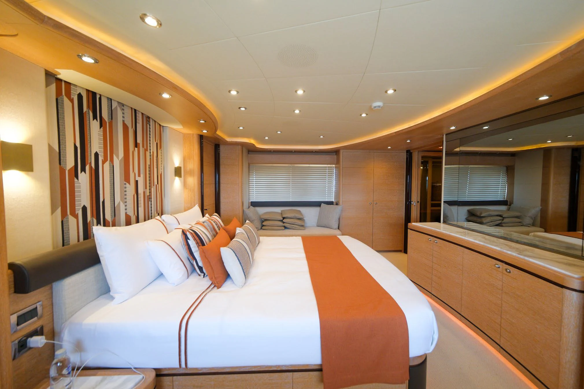 a room with a bed and a mirror aboard AERO Yacht for Charter