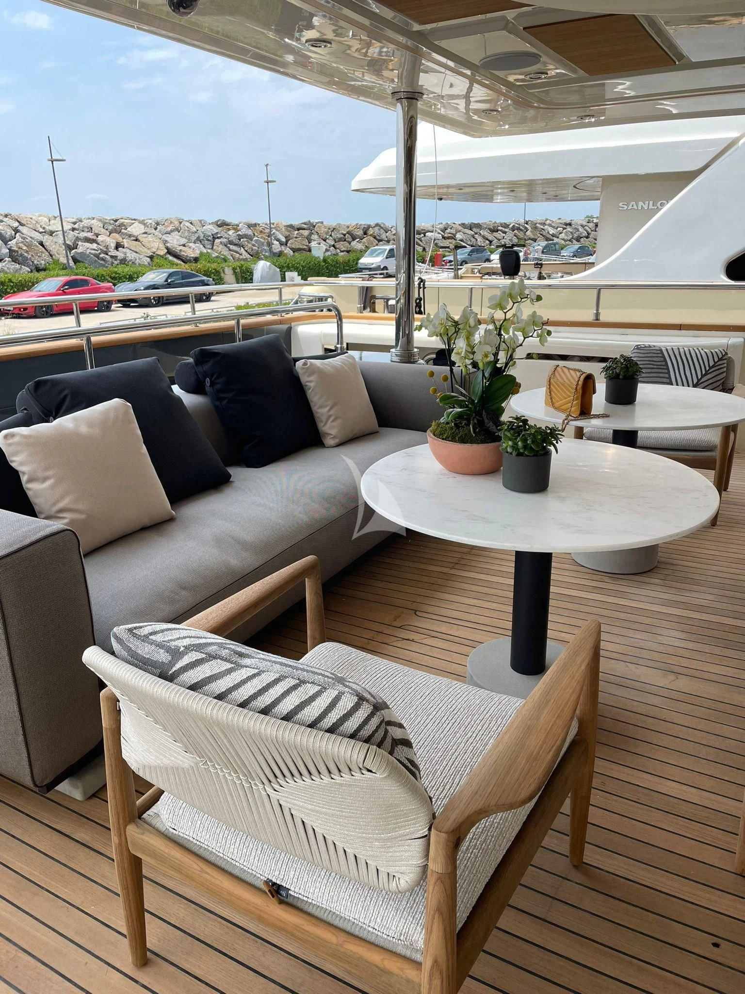 a couch and a table in a room with a view of a city aboard AERO Yacht for Charter