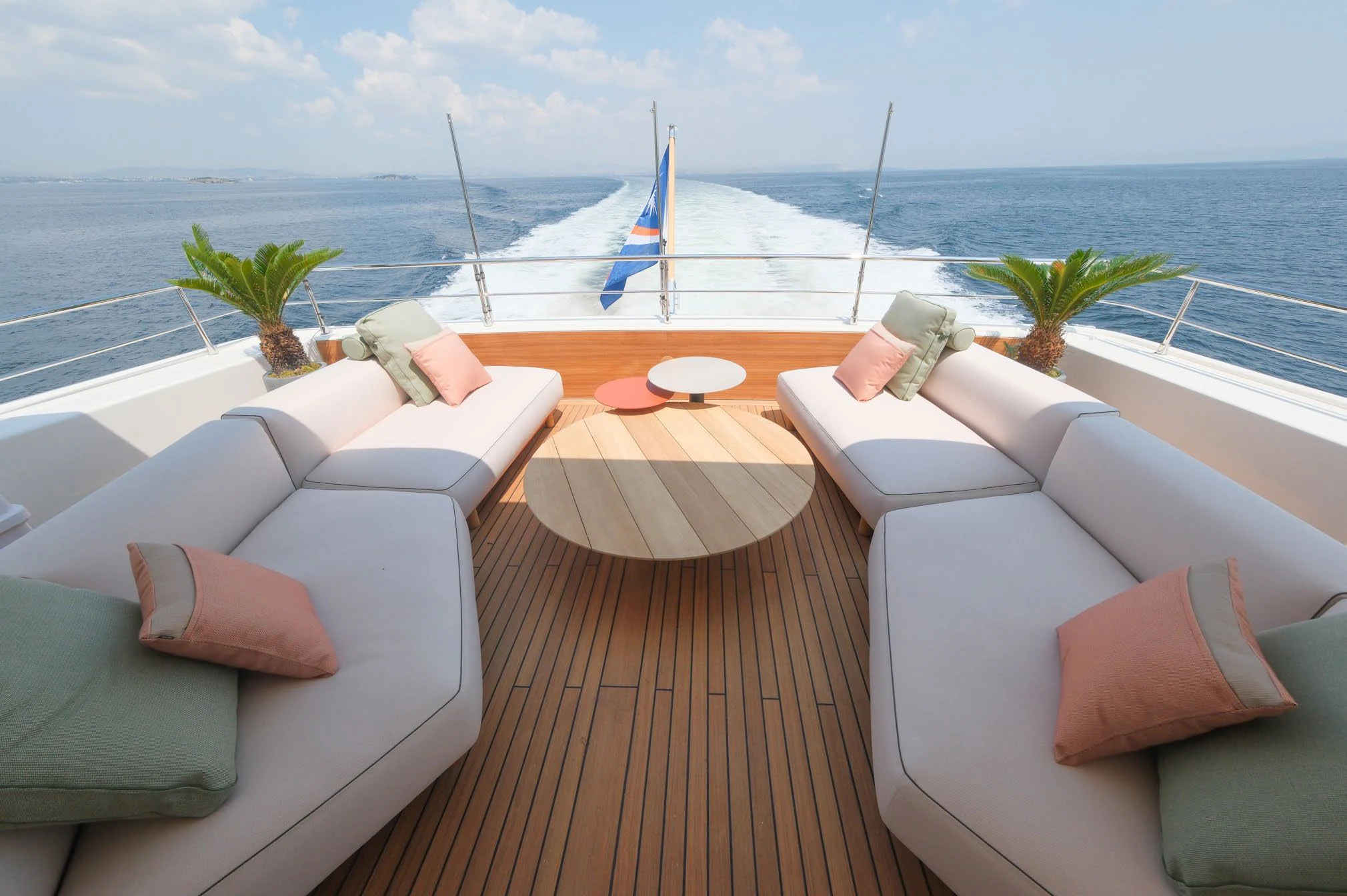 a deck with lounge chairs and a body of water aboard AERO Yacht for Charter