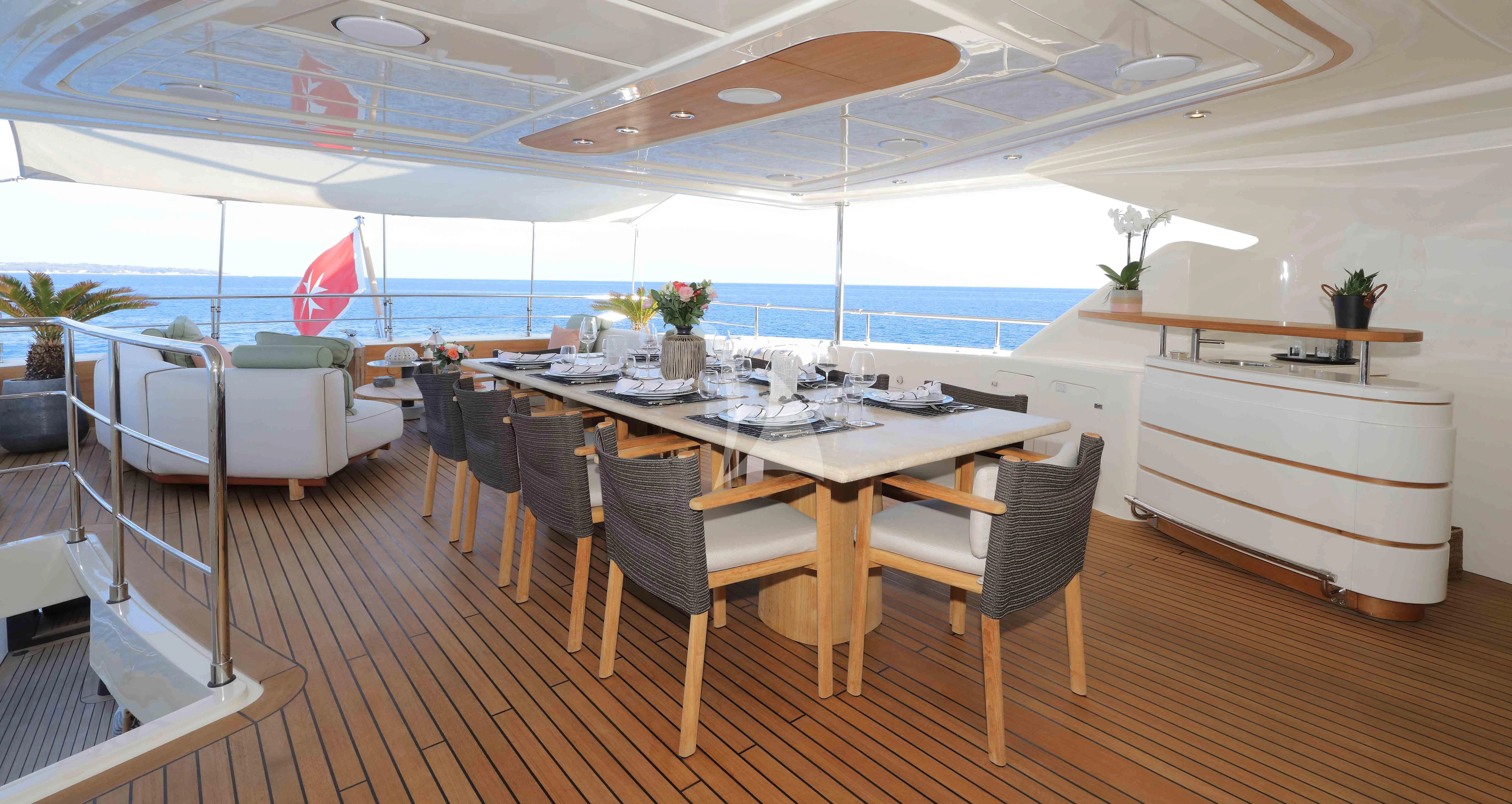 a large room with a table and chairs aboard AERO Yacht for Charter