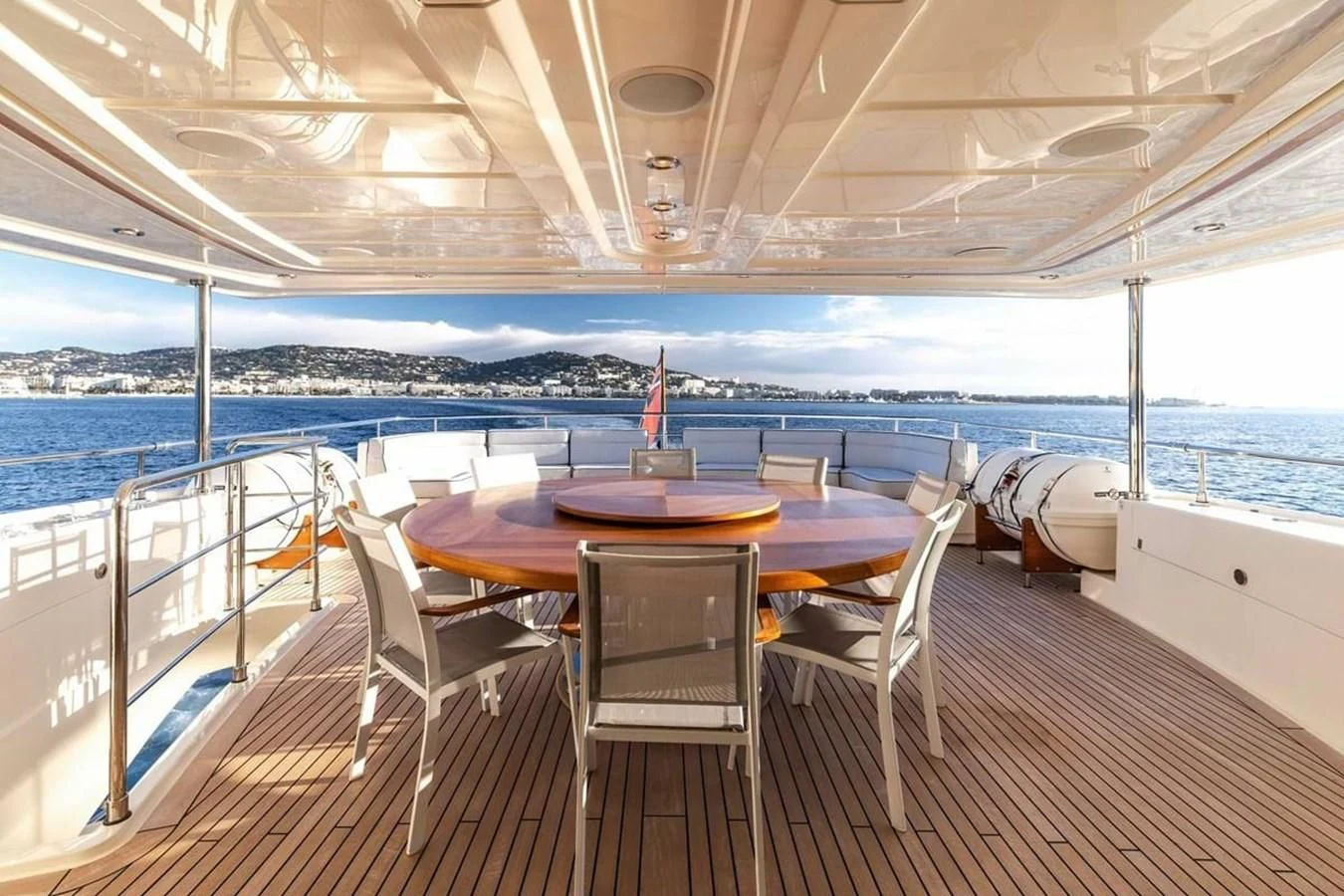 a table and chairs on a deck aboard AERO Yacht for Charter