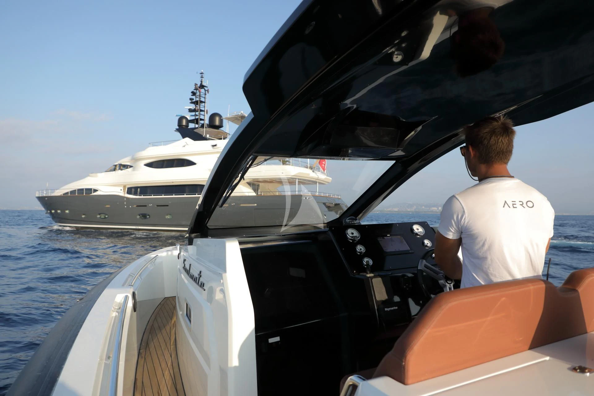a person driving a boat aboard AERO Yacht for Charter
