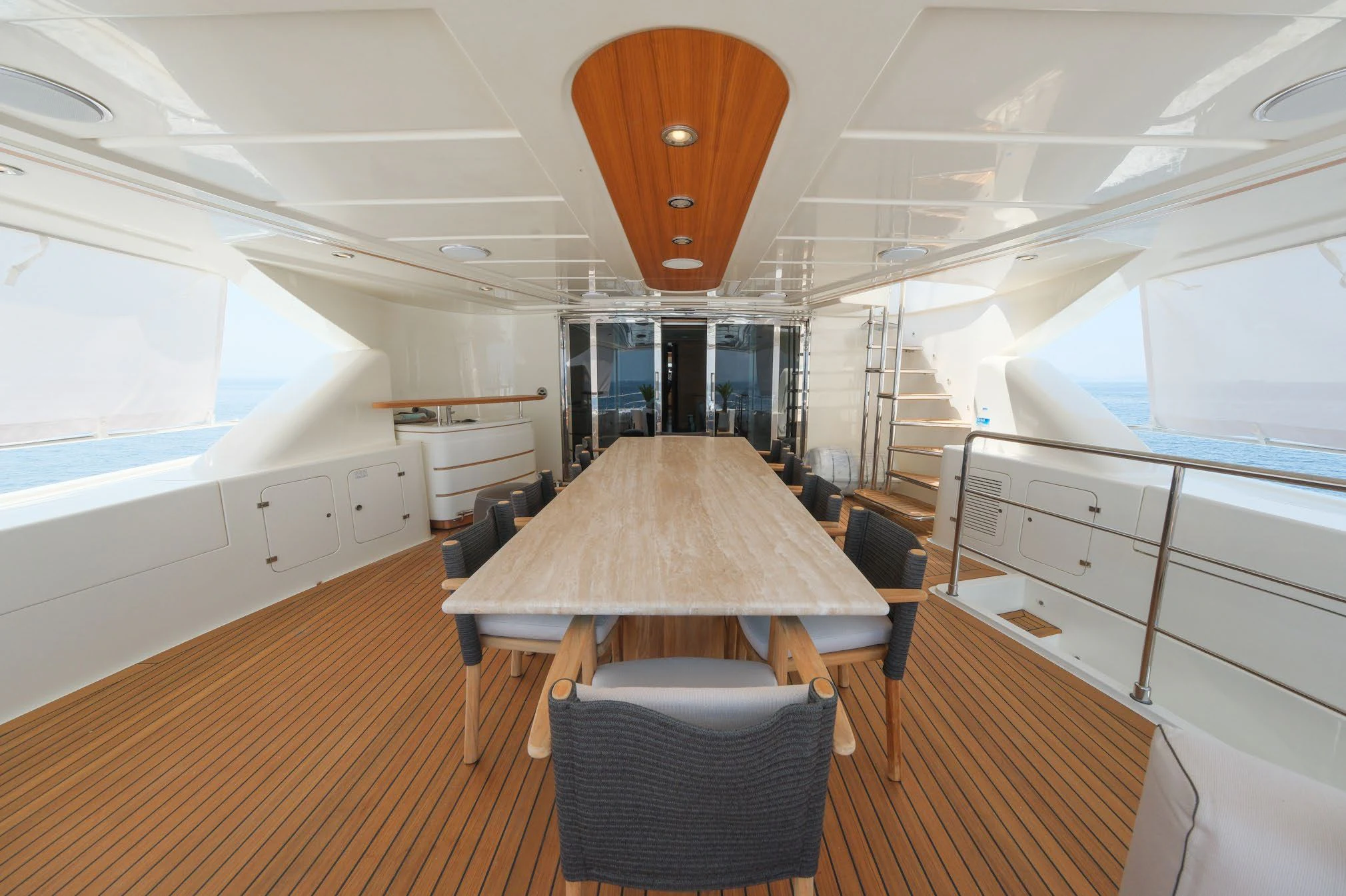 a large room with a table and chairs aboard AERO Yacht for Charter