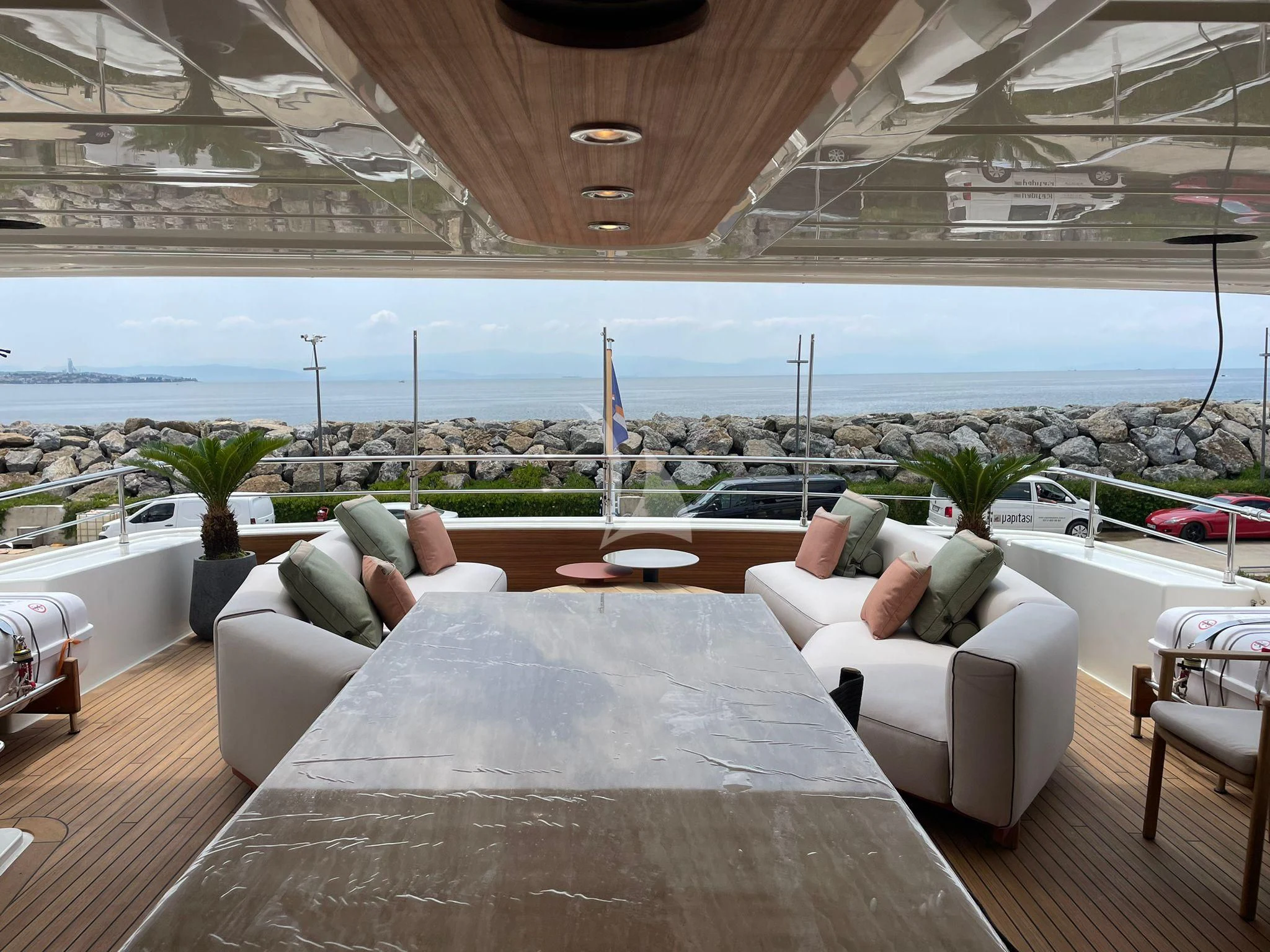 a large living room with a large patio and a view of the ocean aboard AERO Yacht for Charter