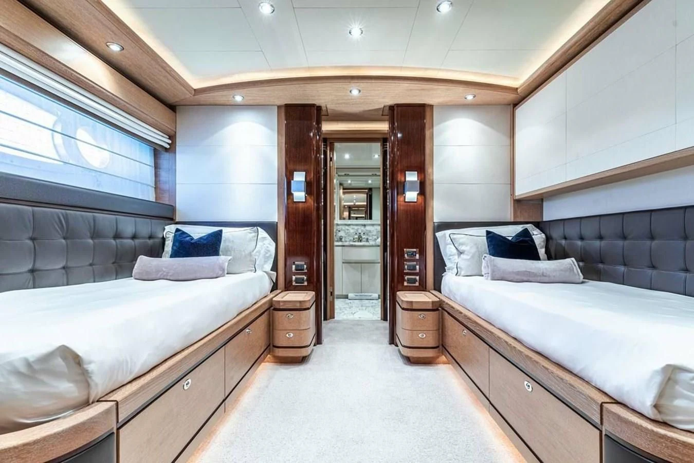 a room with a couple of beds aboard AERO Yacht for Charter