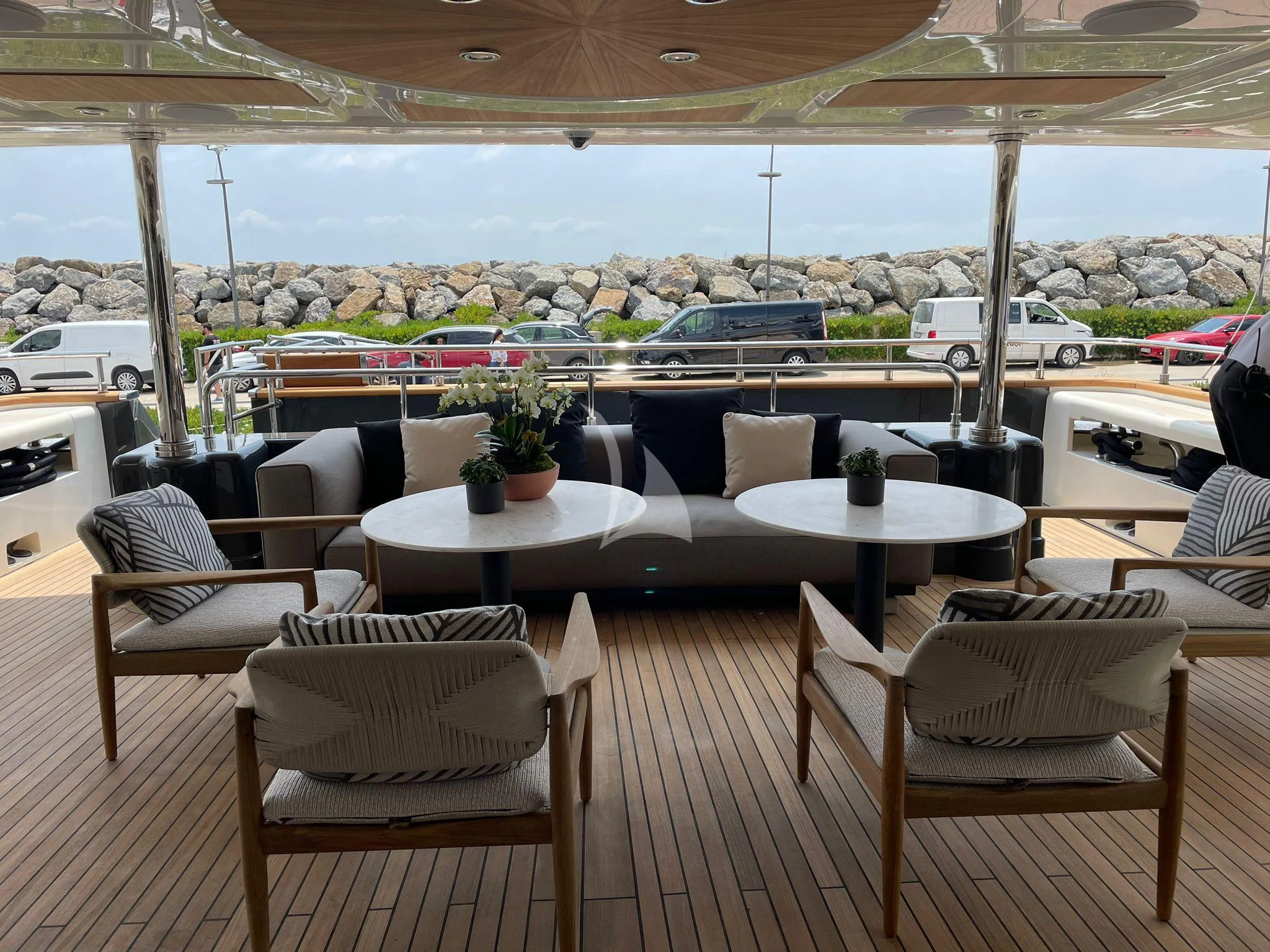 a patio with tables and chairs aboard AERO Yacht for Charter