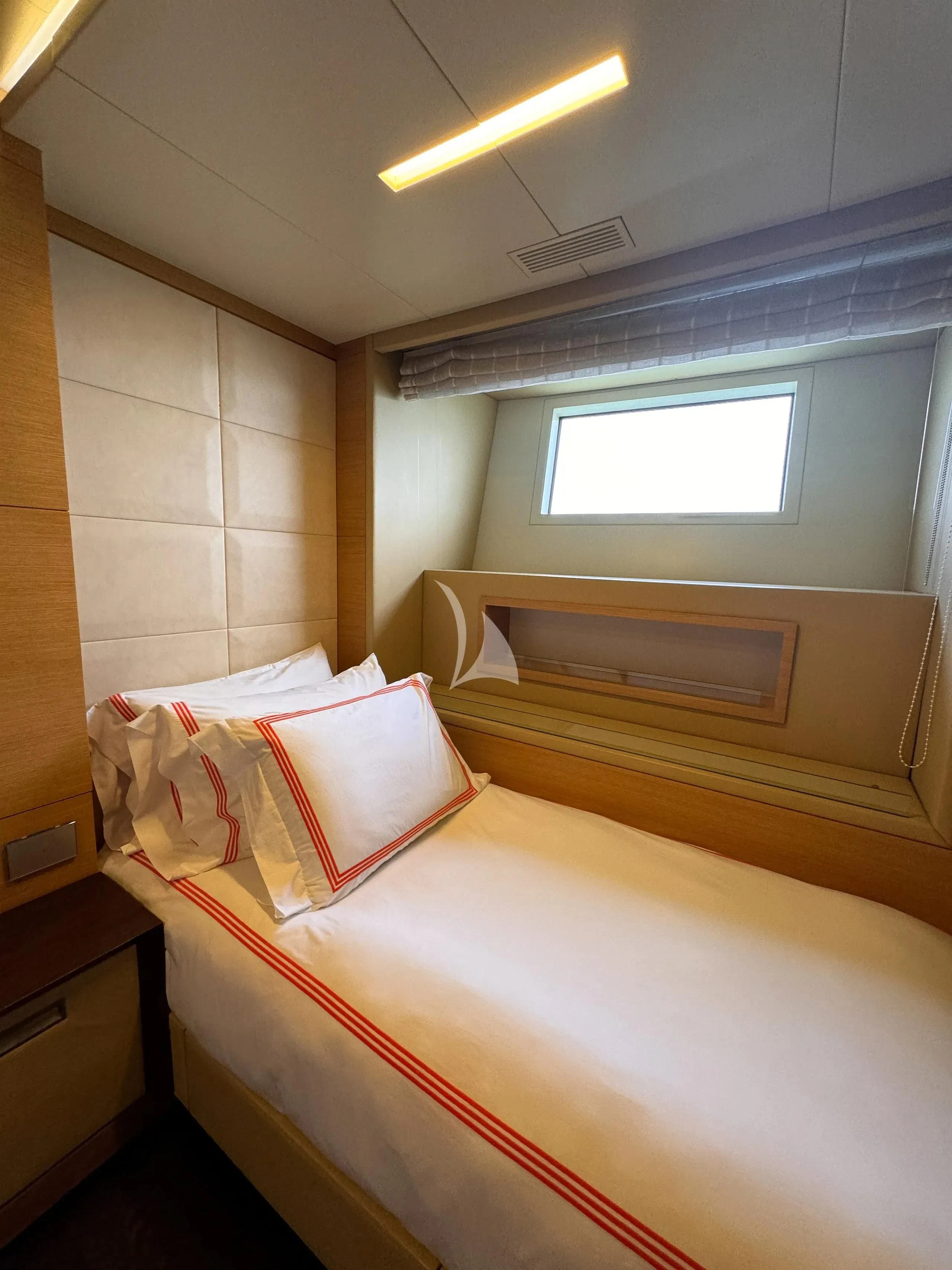 a bed with a white comforter aboard PATIENCE Yacht for Charter