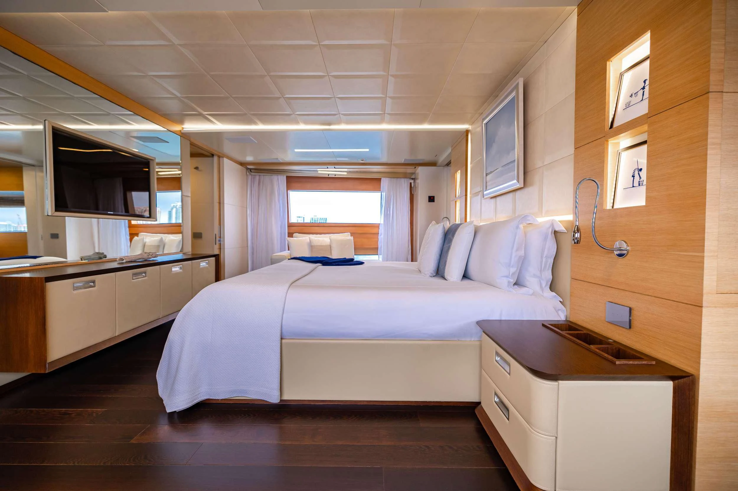 a bedroom with a bed and desk aboard PATIENCE Yacht for Charter