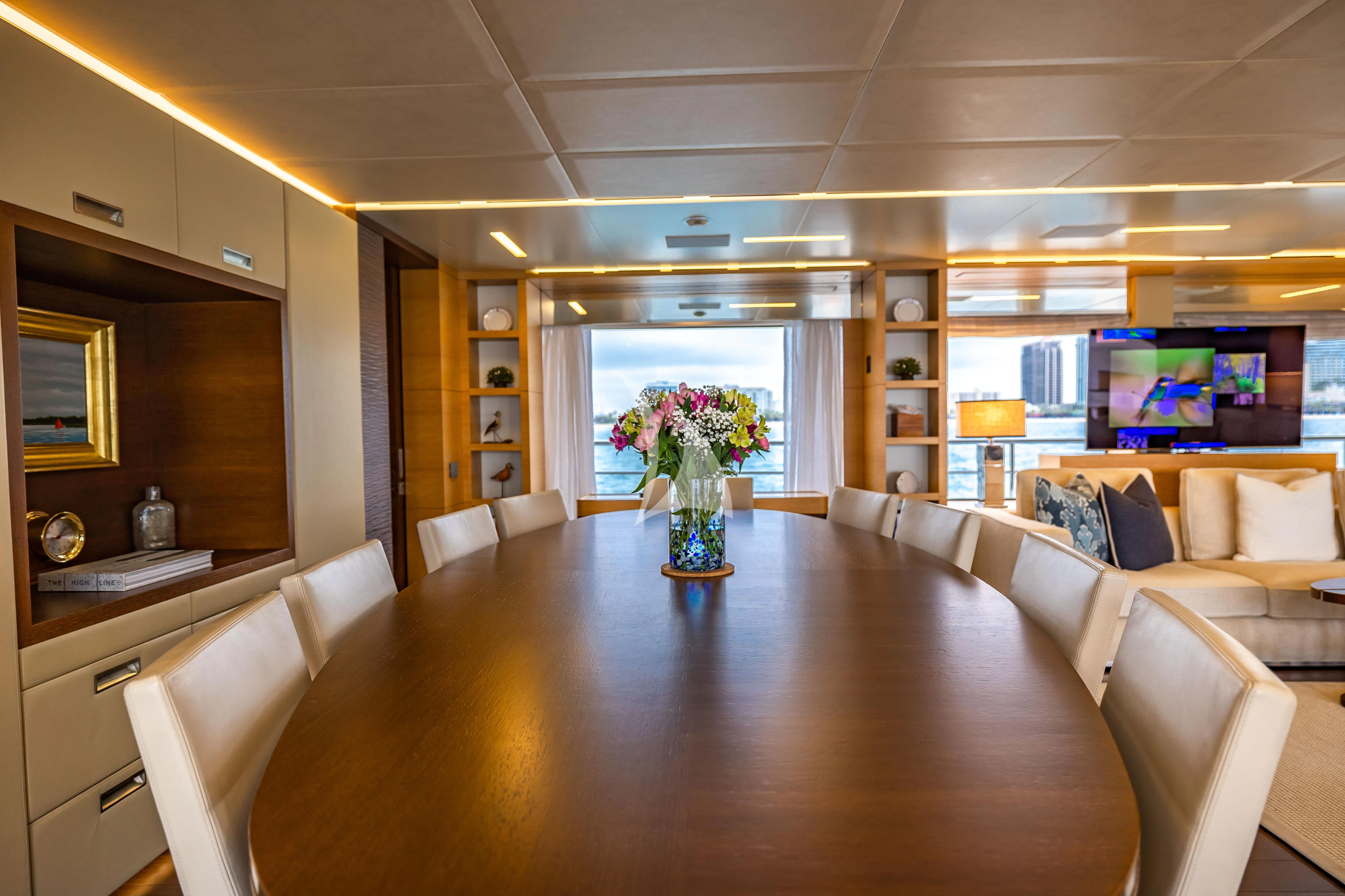 a large living room with a wood floor and white couches aboard PATIENCE Yacht for Charter