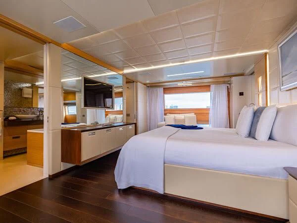 a bedroom with a bed and a desk aboard PATIENCE Yacht for Charter