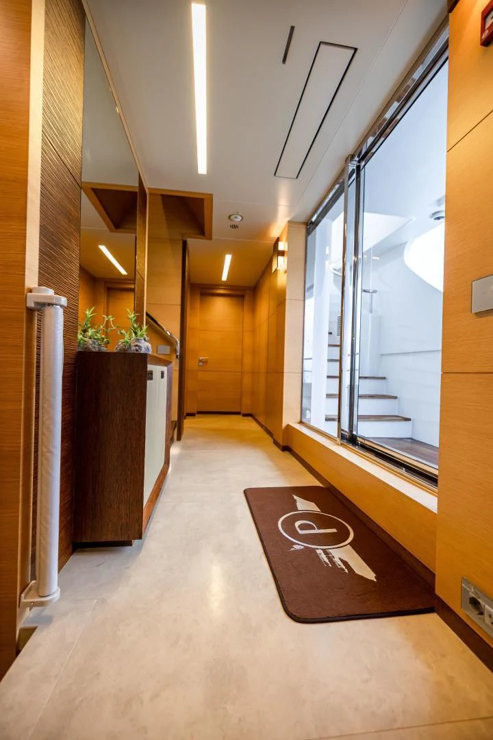a hallway with a door and a window aboard PATIENCE Yacht for Charter