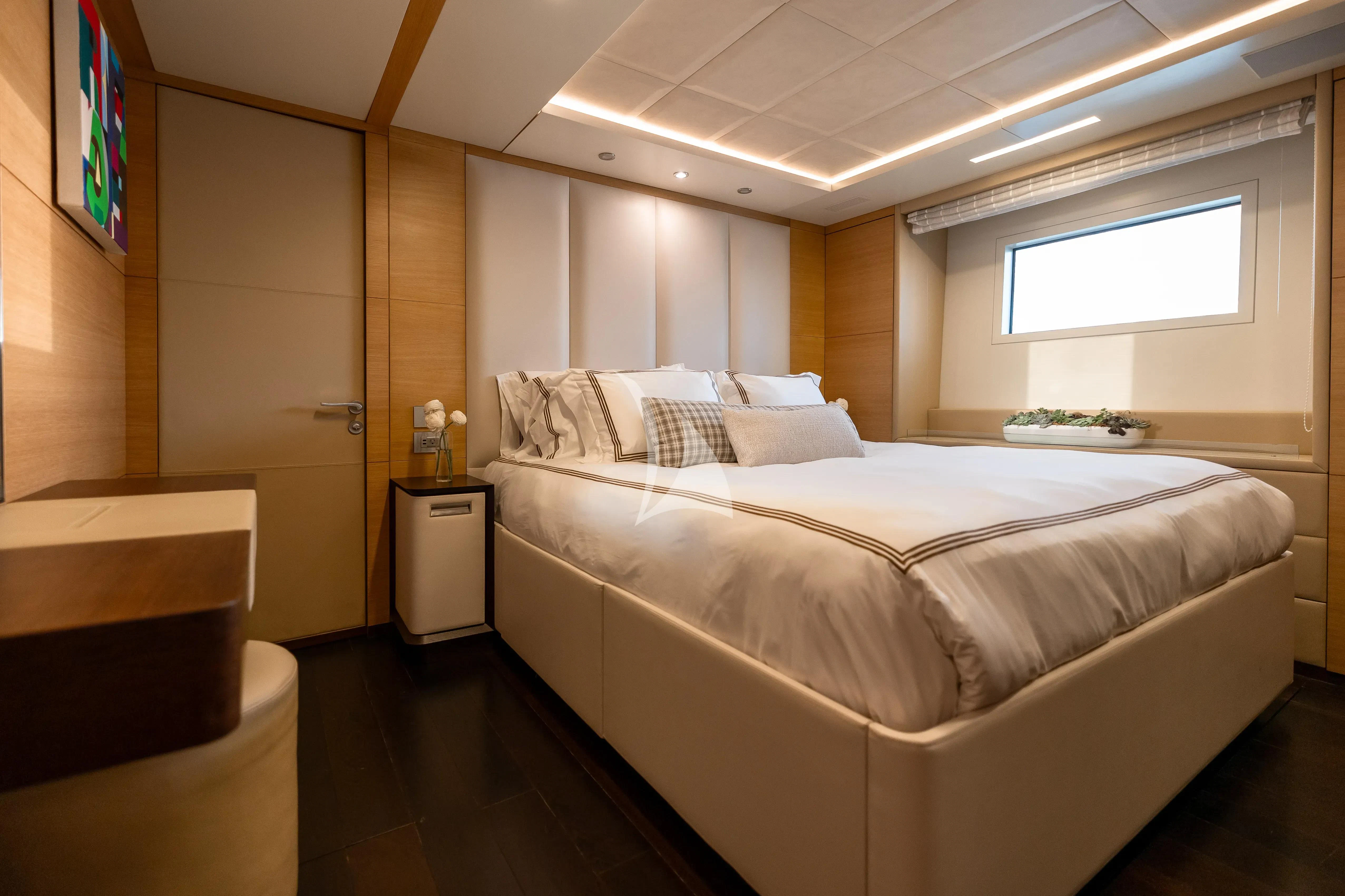 a bedroom with a bed and a window aboard PATIENCE Yacht for Charter