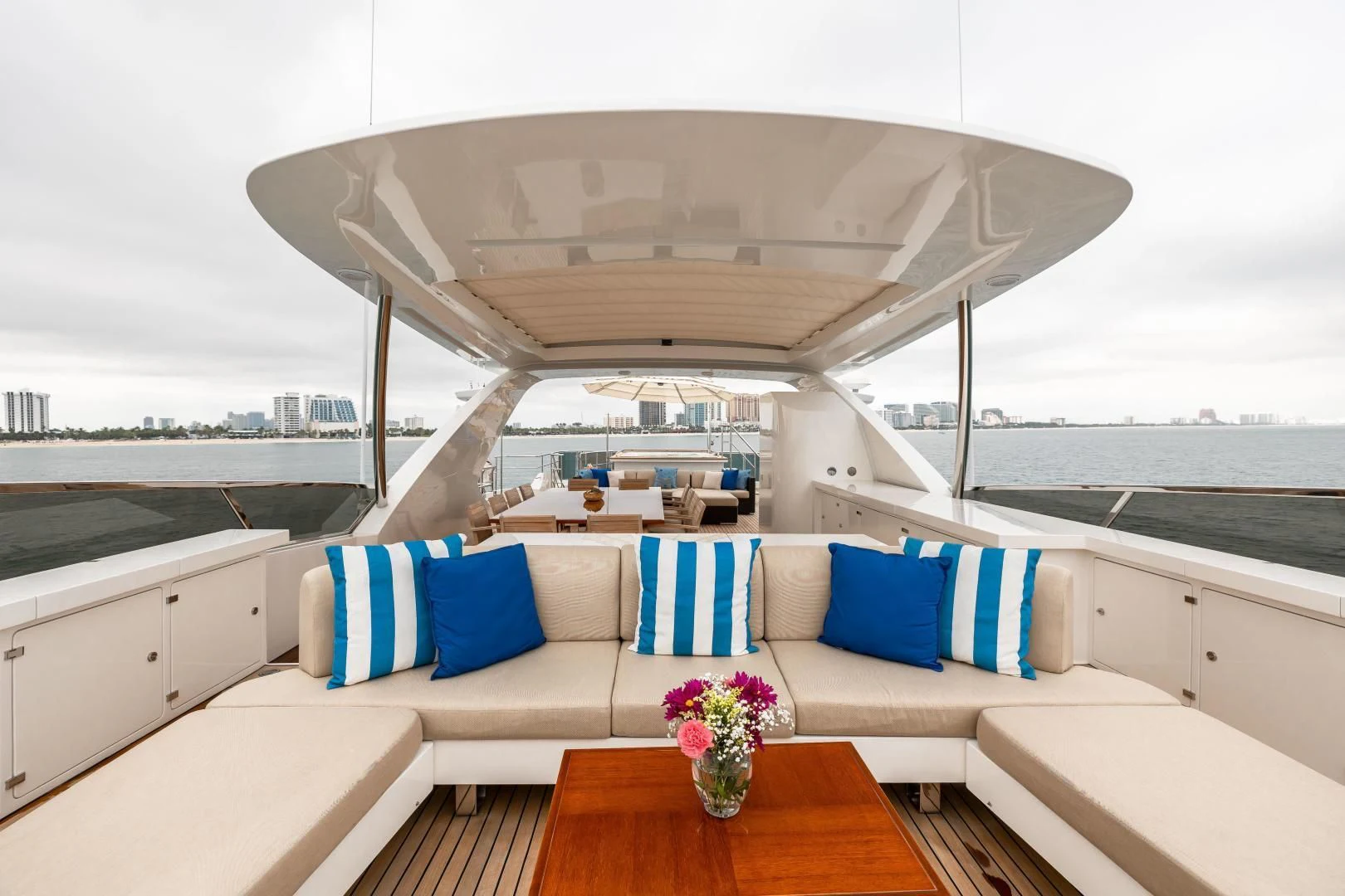 a white couch with blue and pink pillows on it aboard PATIENCE Yacht for Charter