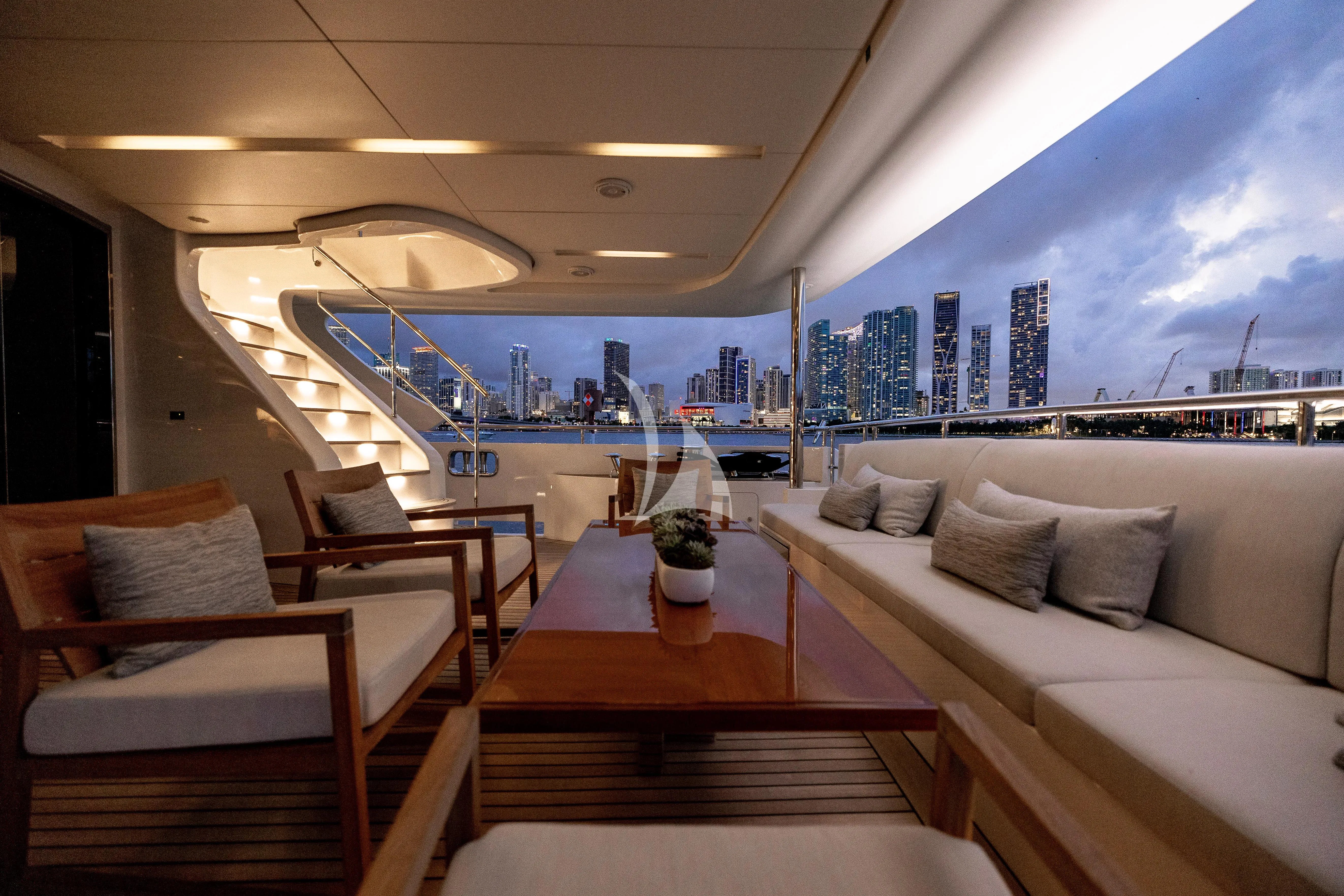 a room with a view of a city and a large ship aboard PATIENCE Yacht for Charter