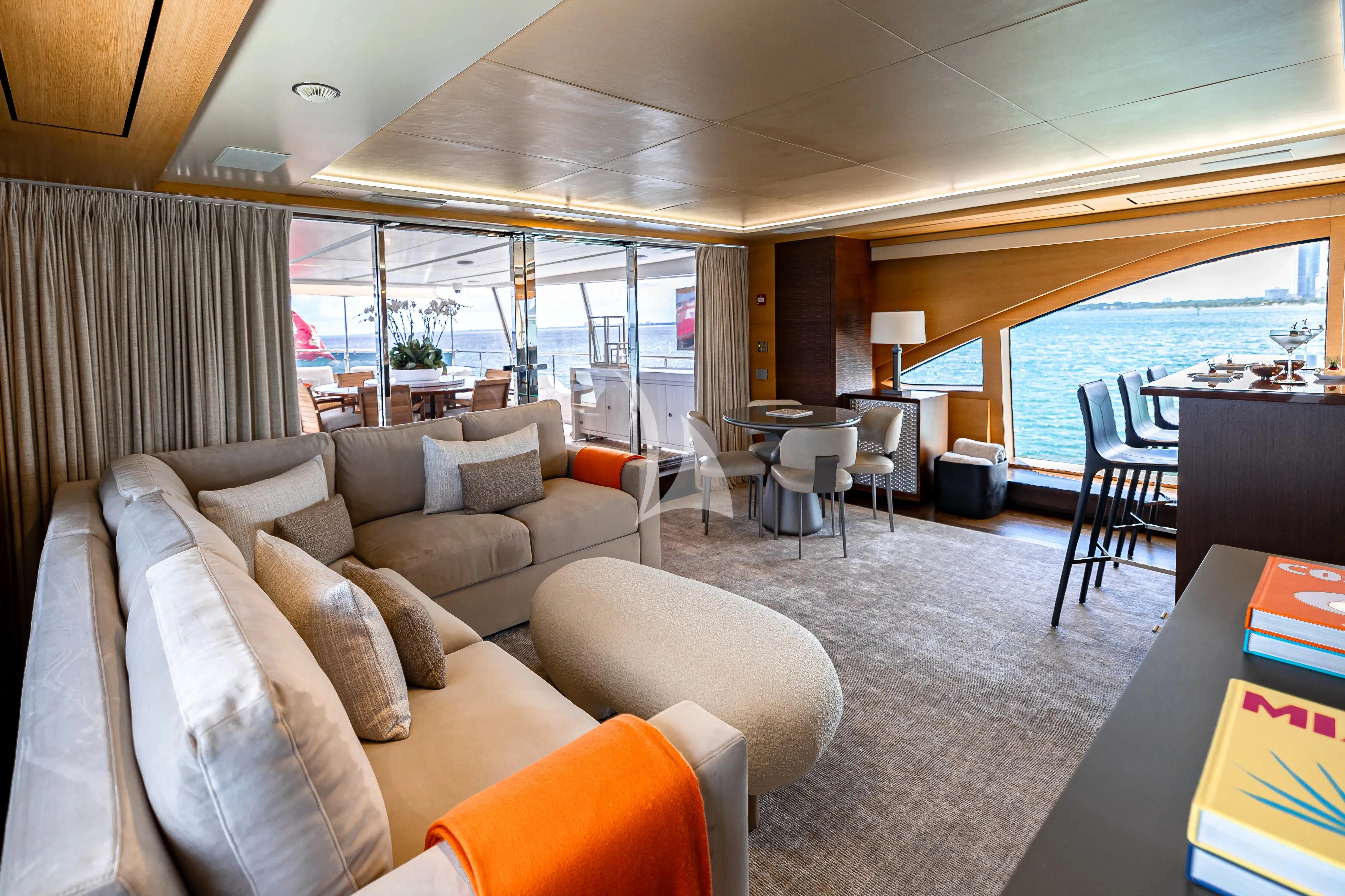 a living room with a large window aboard PATIENCE Yacht for Charter