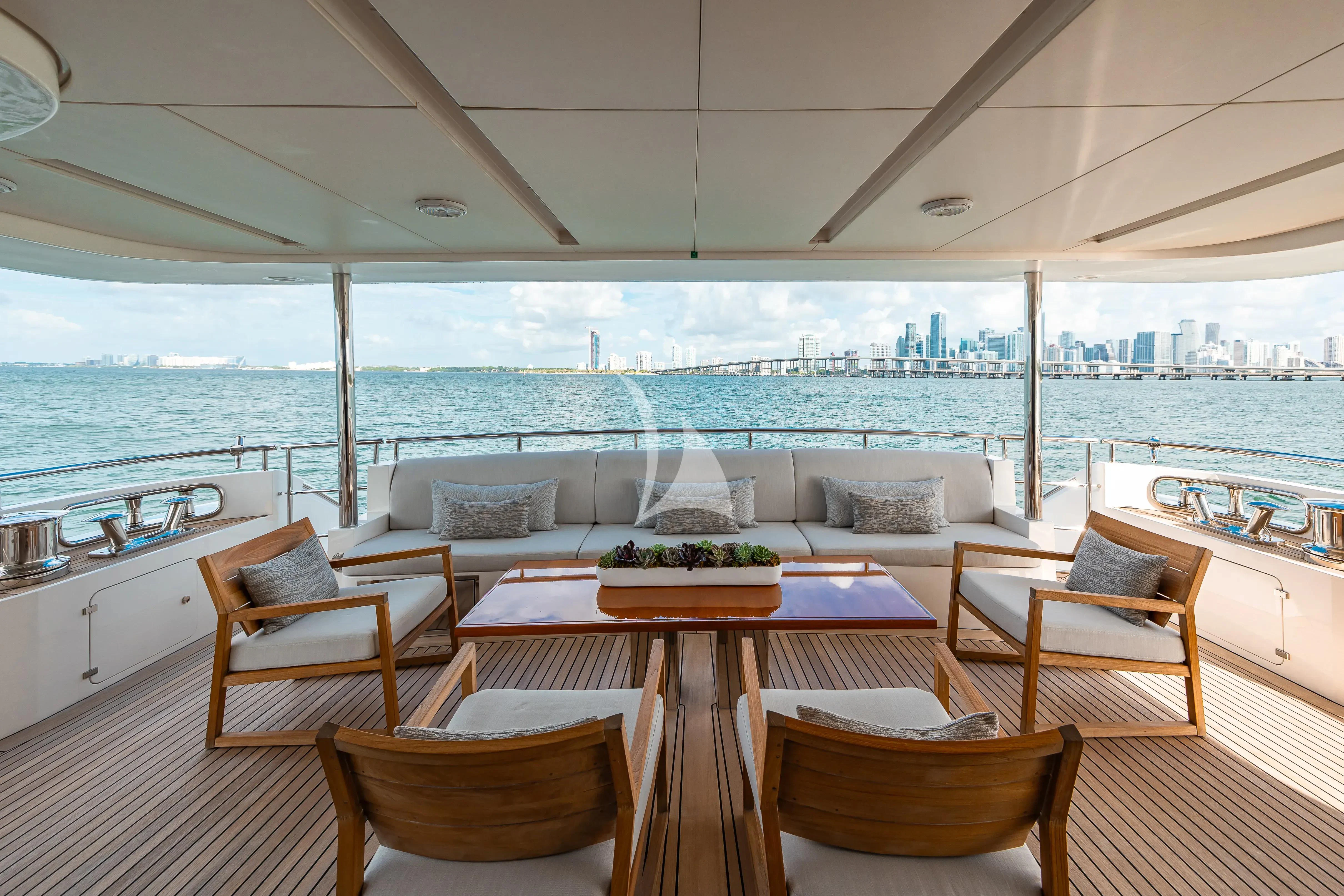 a table and chairs on a deck aboard PATIENCE Yacht for Charter