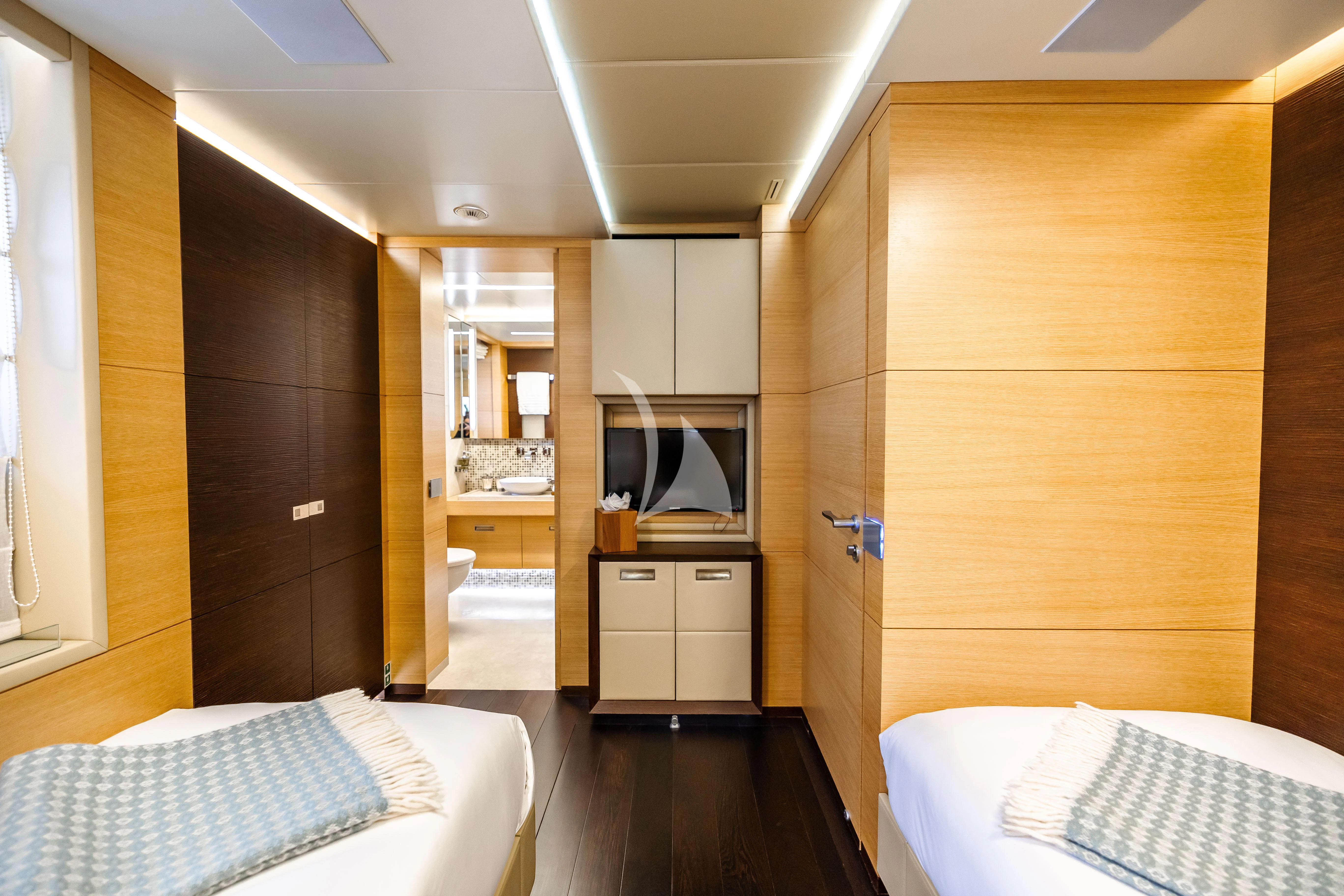 a room with a bed and a television aboard PATIENCE Yacht for Charter