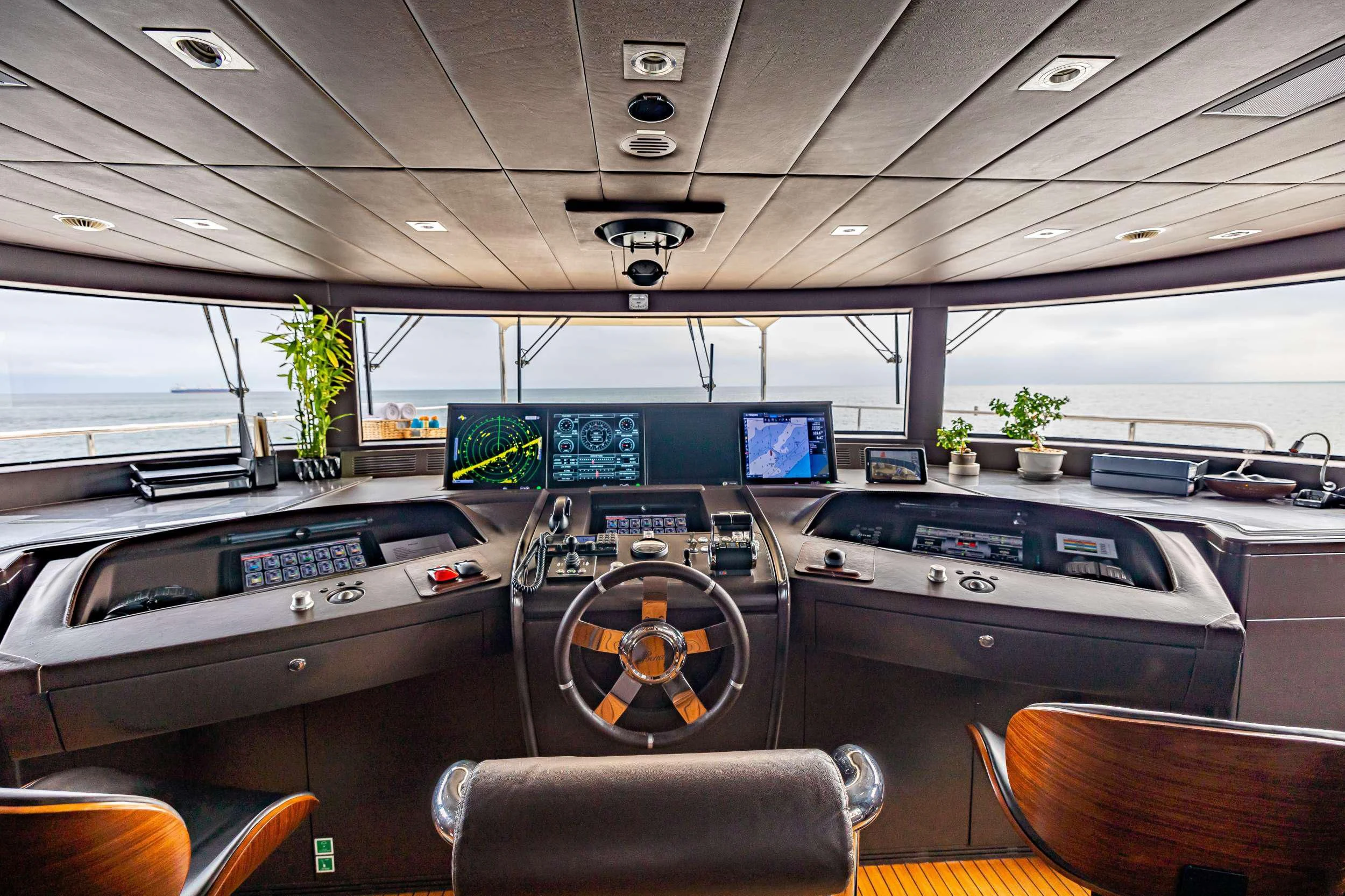 inside of a vehicle with a large screen and a steering wheel aboard PATIENCE Yacht for Charter