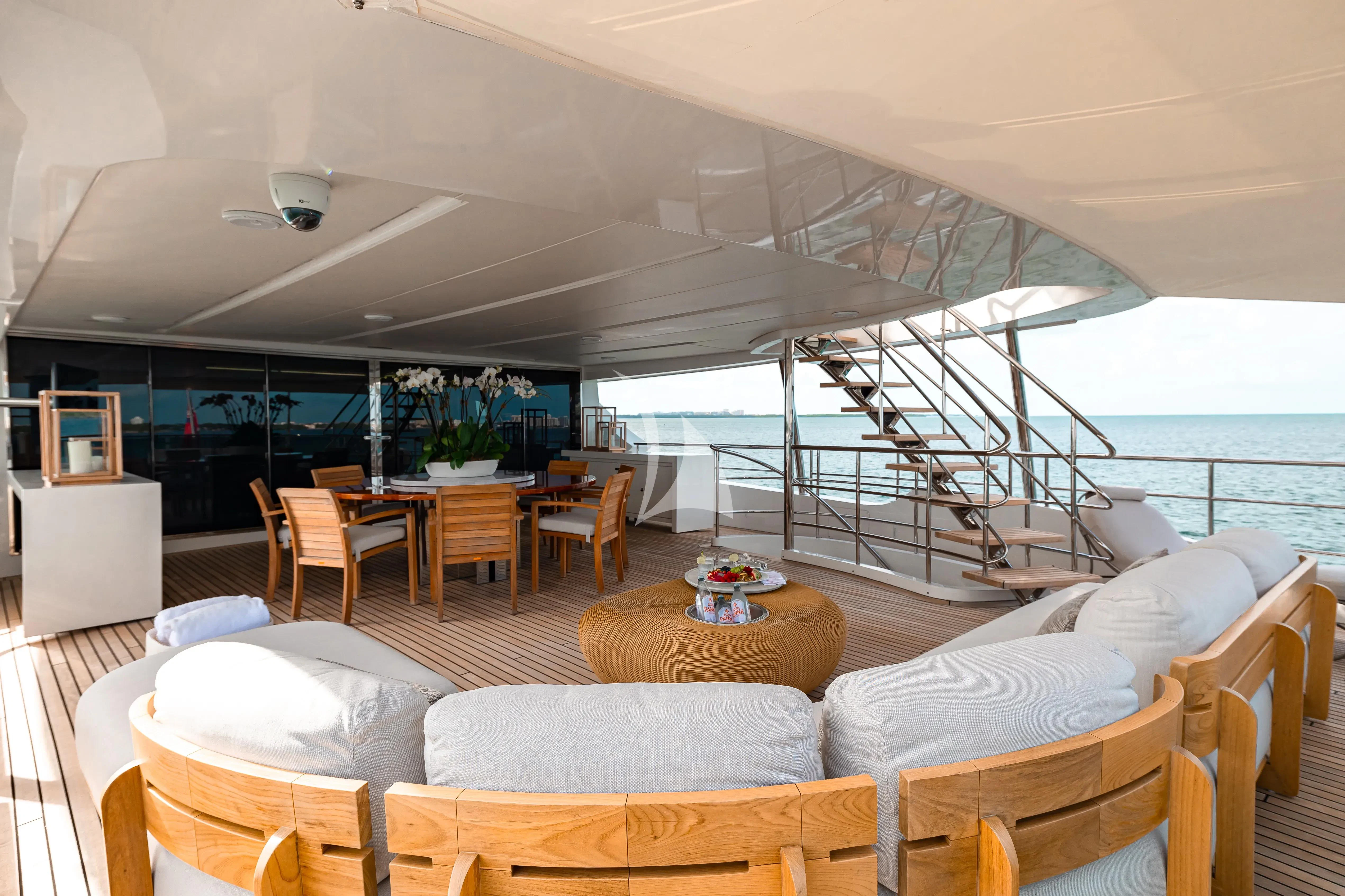 a living room with a large balcony aboard PATIENCE Yacht for Charter