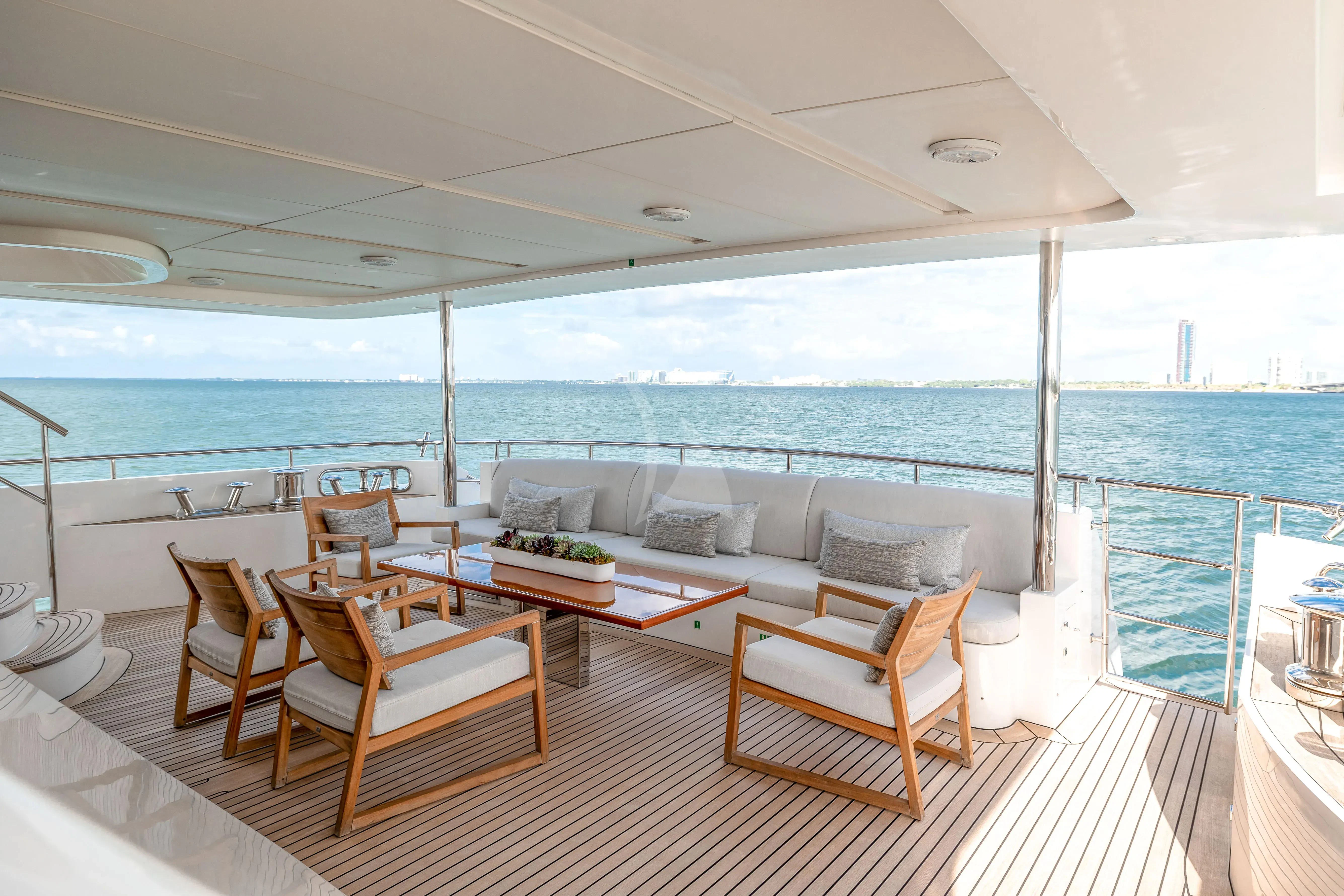 a large living room with a large balcony overlooking the ocean aboard PATIENCE Yacht for Charter