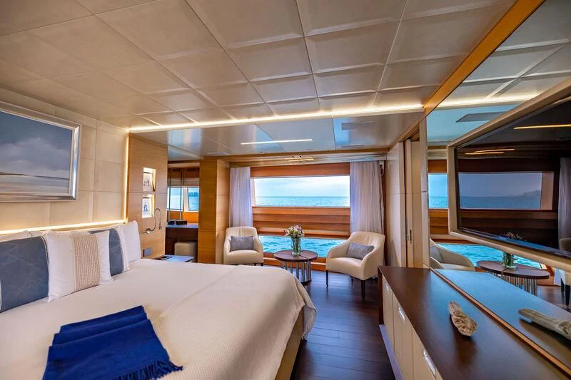 a room with a bed and a tv aboard PATIENCE Yacht for Charter