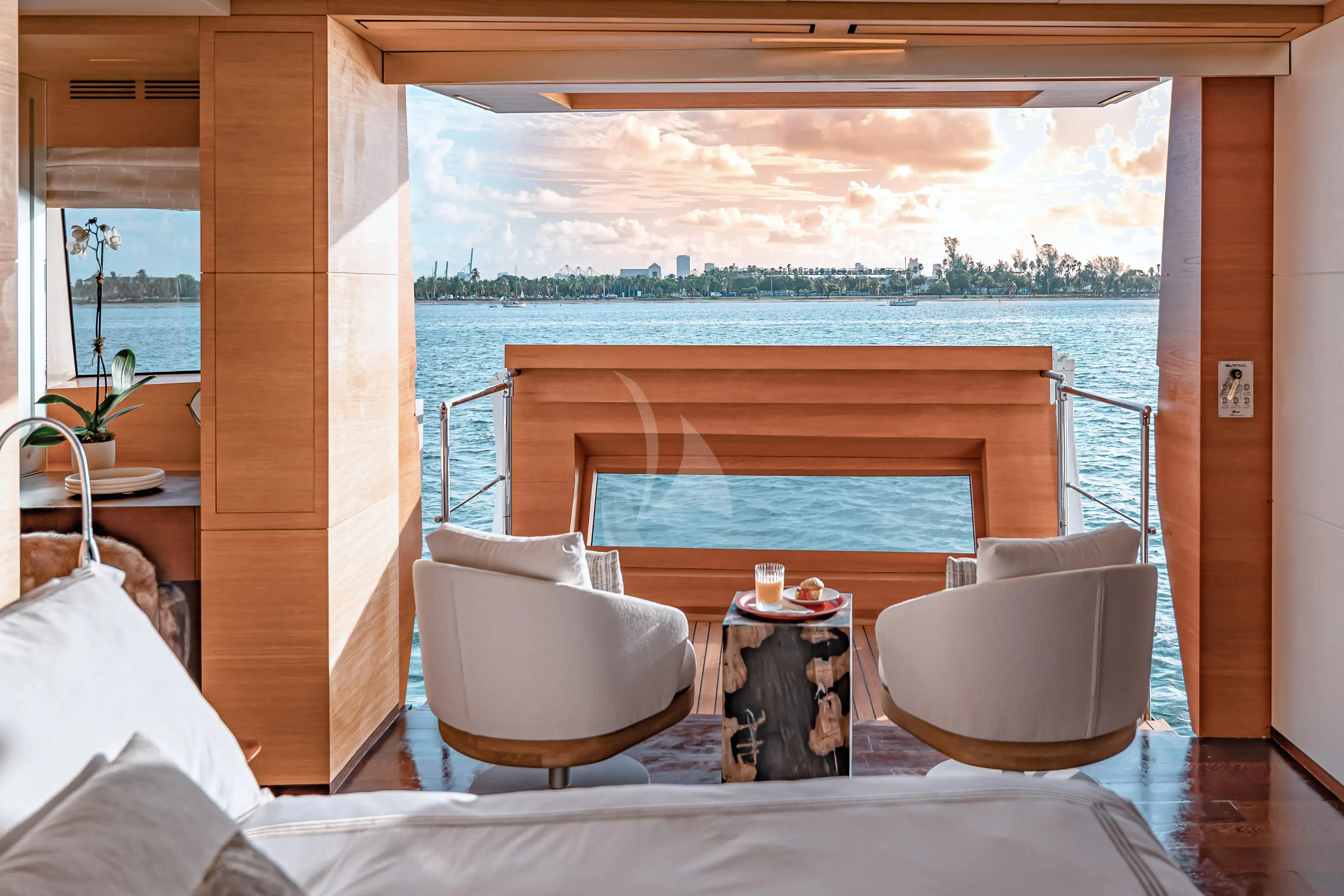 a room with a bed and a chair aboard PATIENCE Yacht for Charter