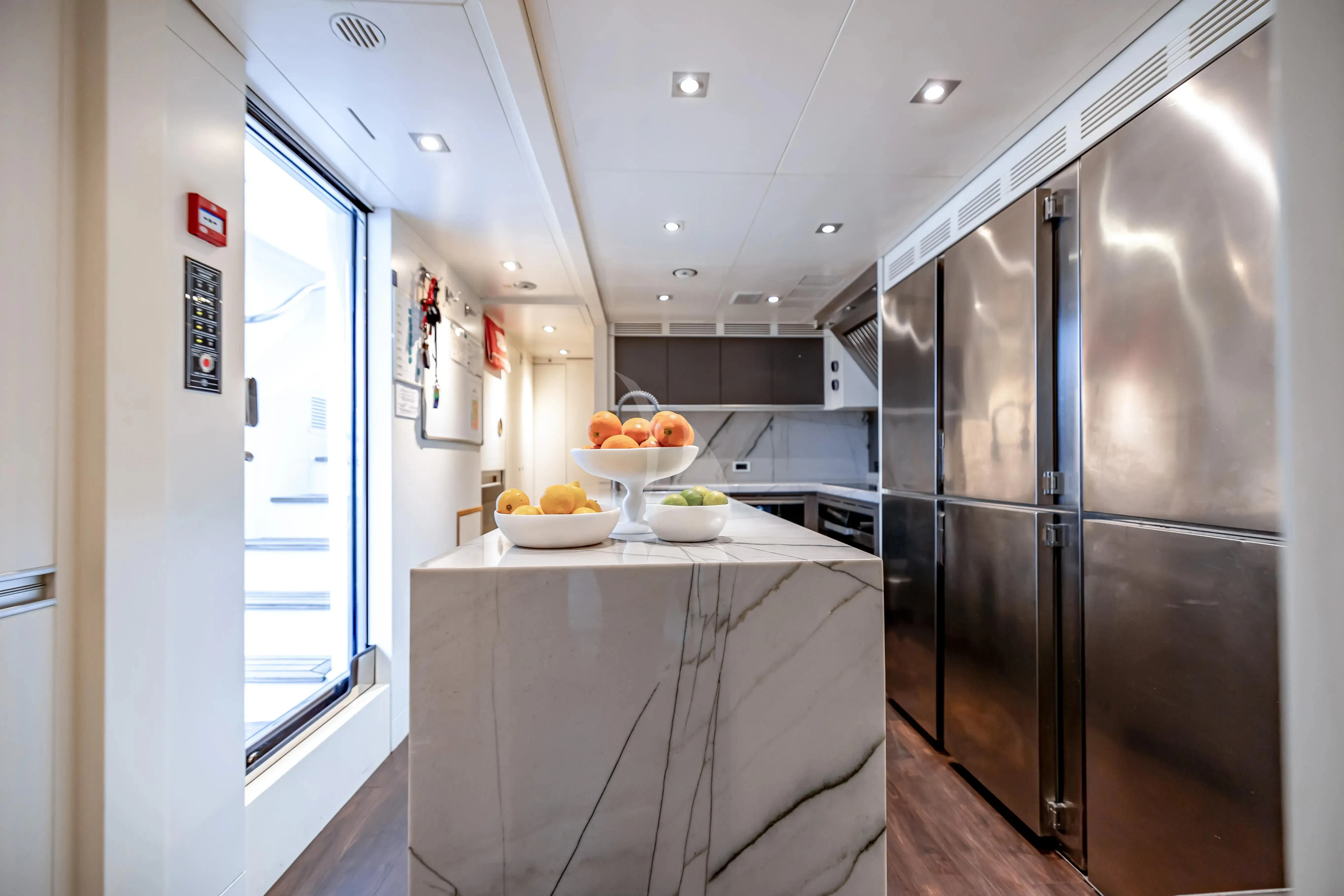 a kitchen with a stainless steel refrigerator aboard PATIENCE Yacht for Charter