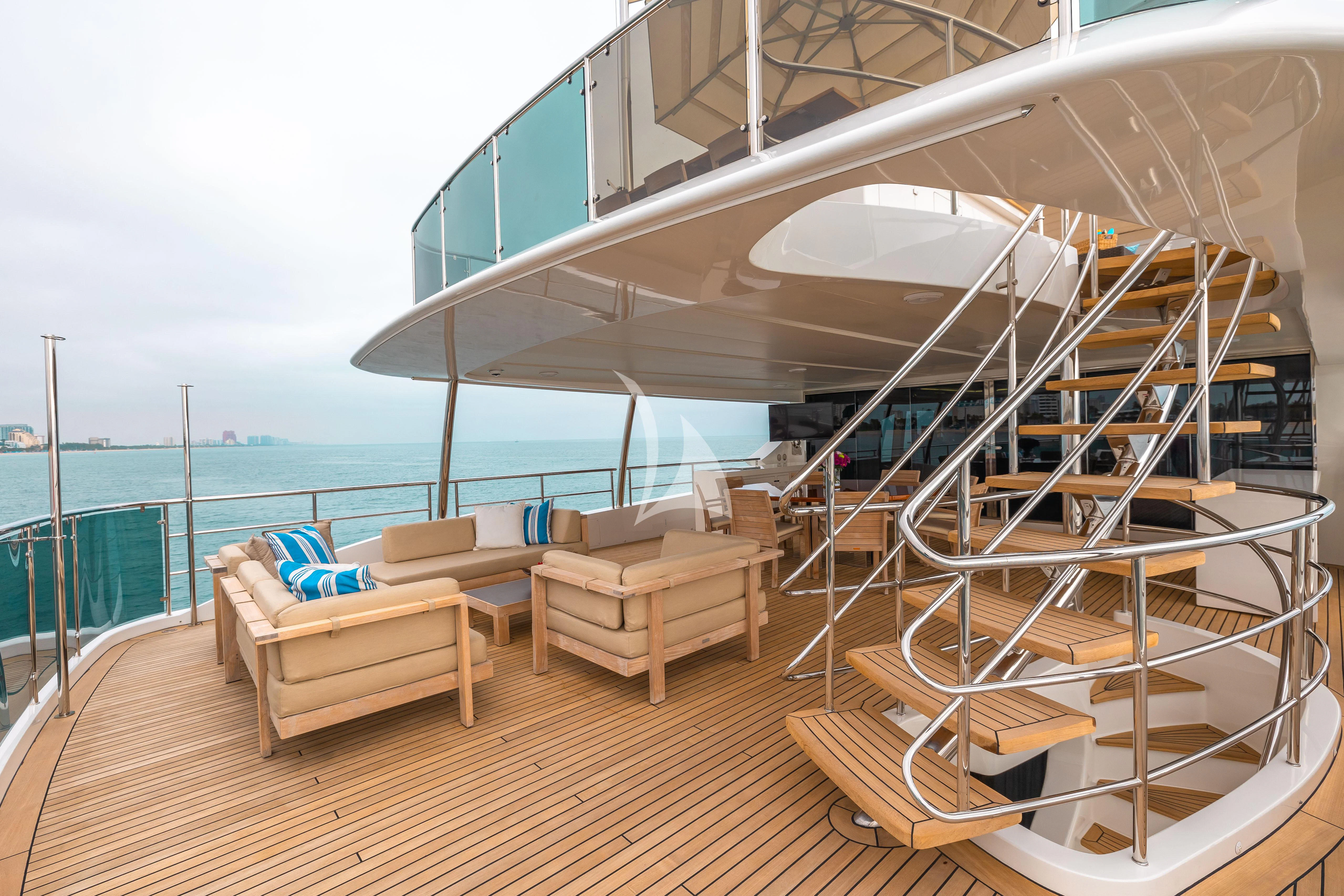 a room with a large deck and a view of the ocean aboard PATIENCE Yacht for Charter