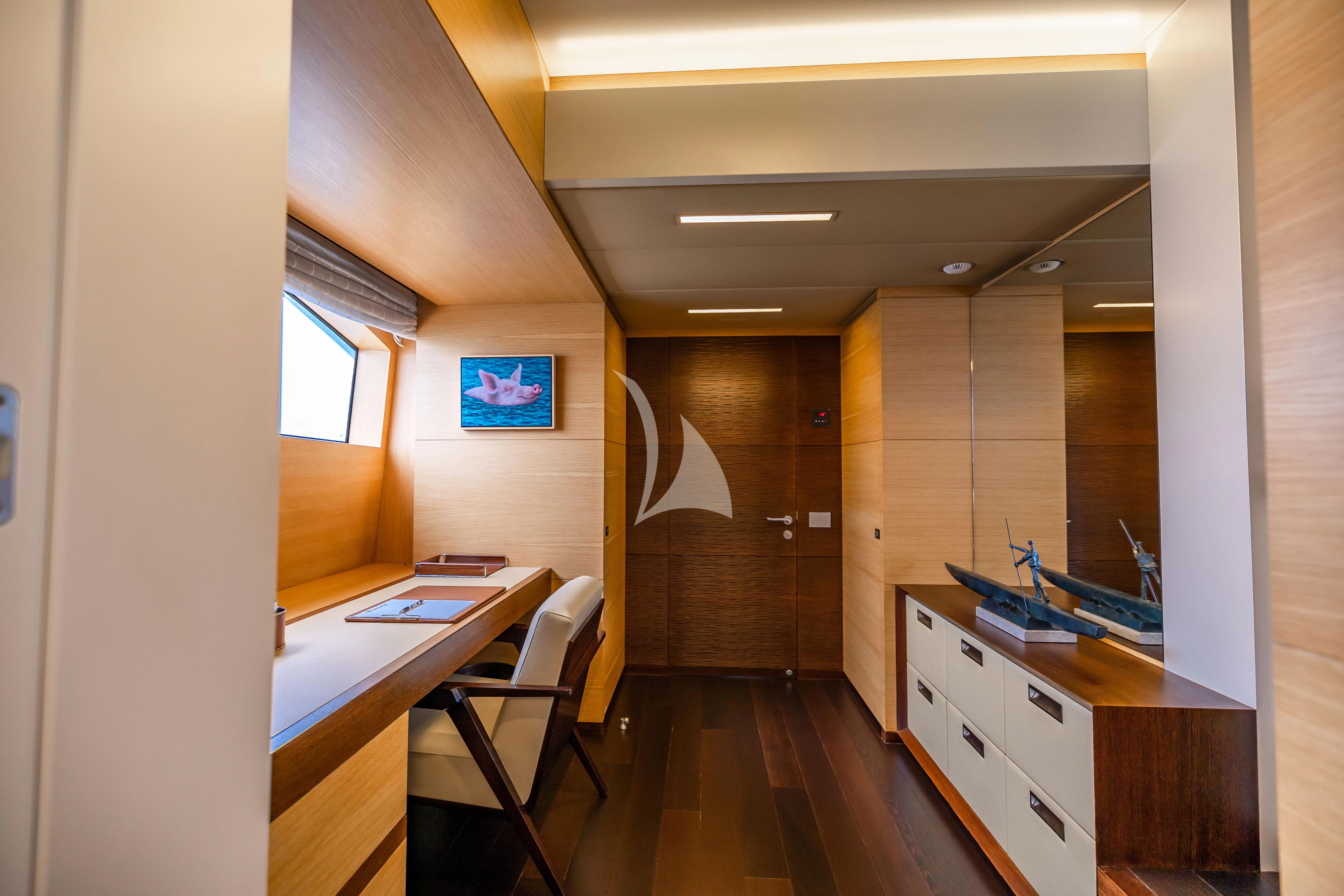 a room with a desk and a computer on the desk aboard PATIENCE Yacht for Charter