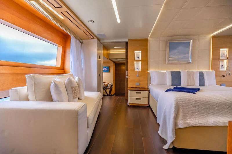 a room with a bed and a couch aboard PATIENCE Yacht for Charter