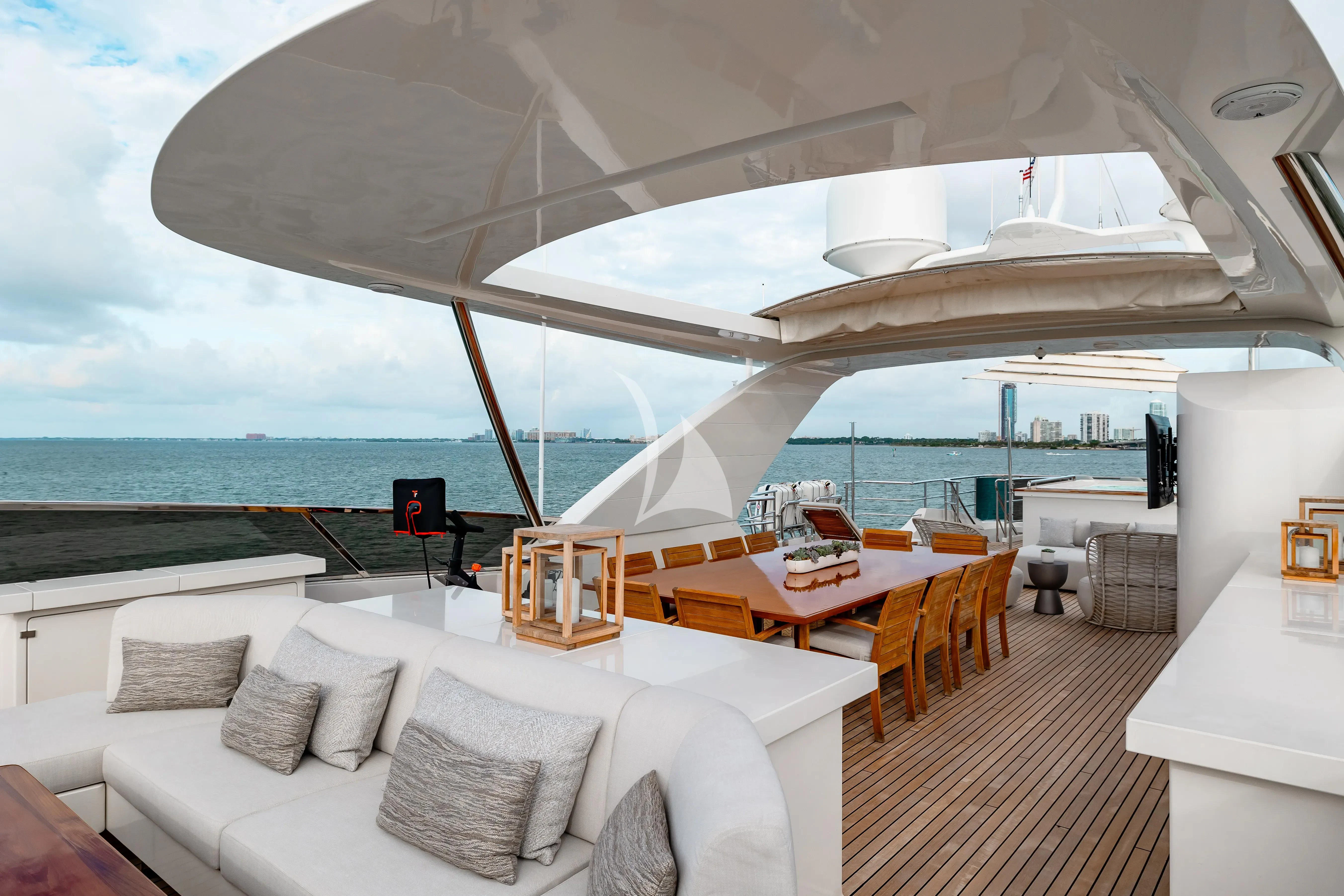 a room with a couch and a table and a large white boat aboard PATIENCE Yacht for Charter