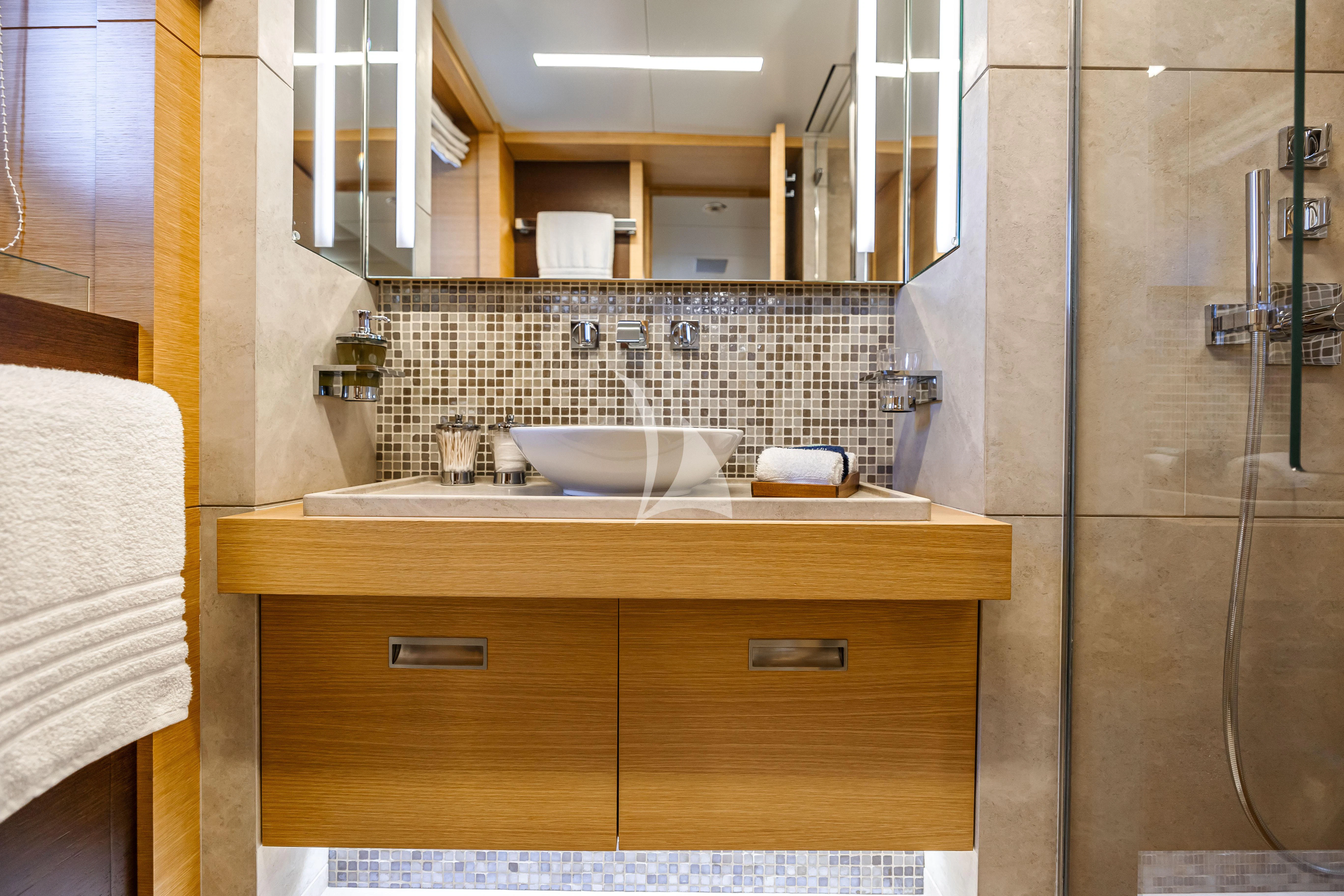 a bathroom with a sink and a mirror aboard PATIENCE Yacht for Charter