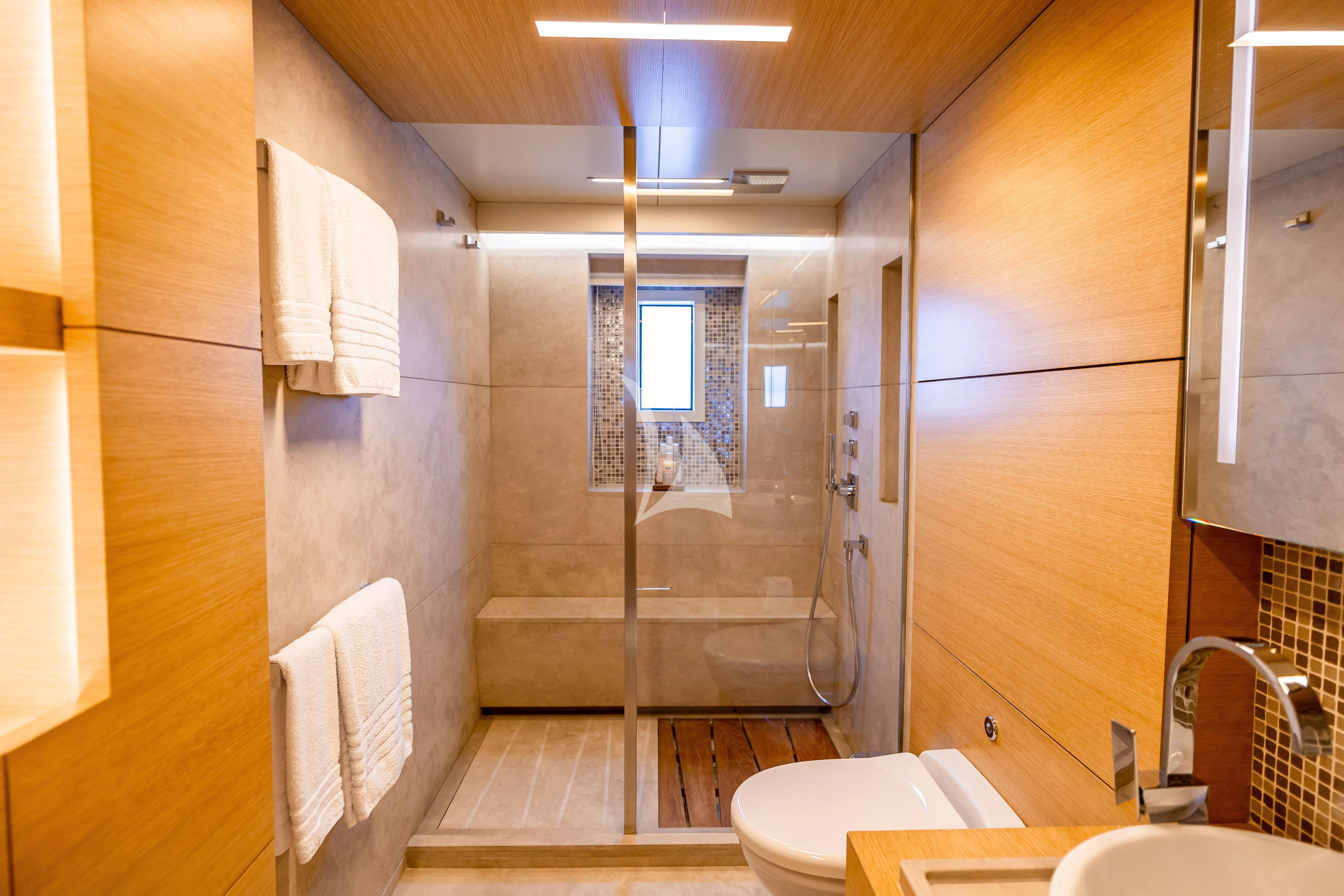 a bathroom with a glass shower aboard PATIENCE Yacht for Charter