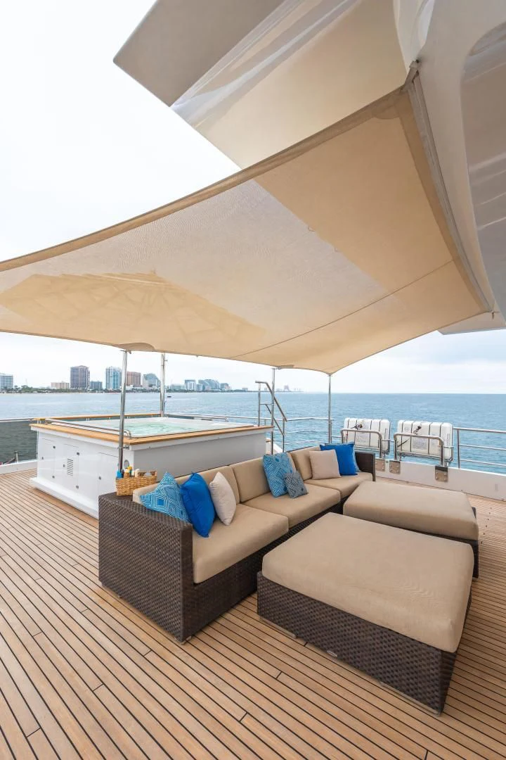 a lounge area with a couch and a large body of water aboard PATIENCE Yacht for Charter