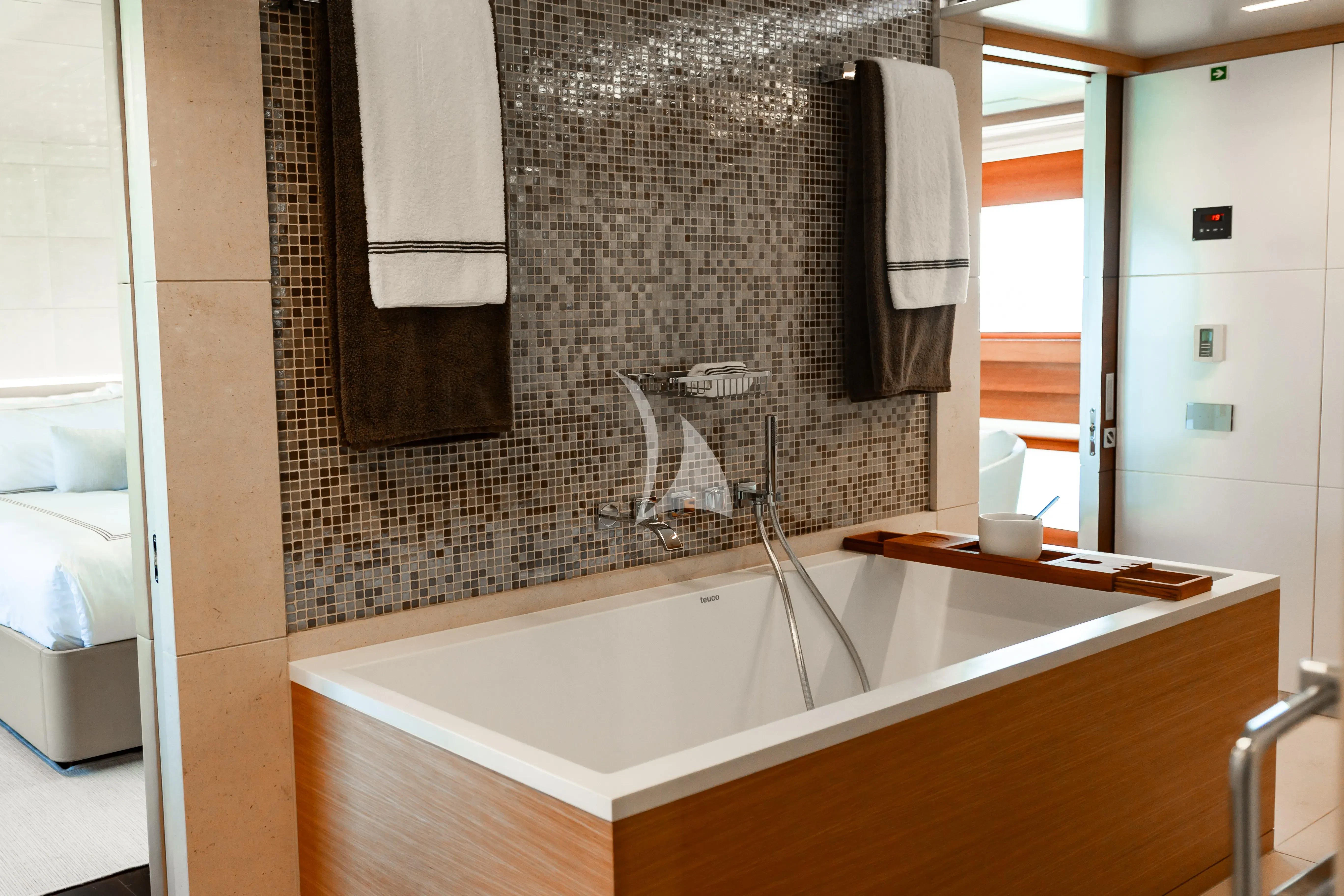 a bathroom with a bathtub and sink aboard PATIENCE Yacht for Charter