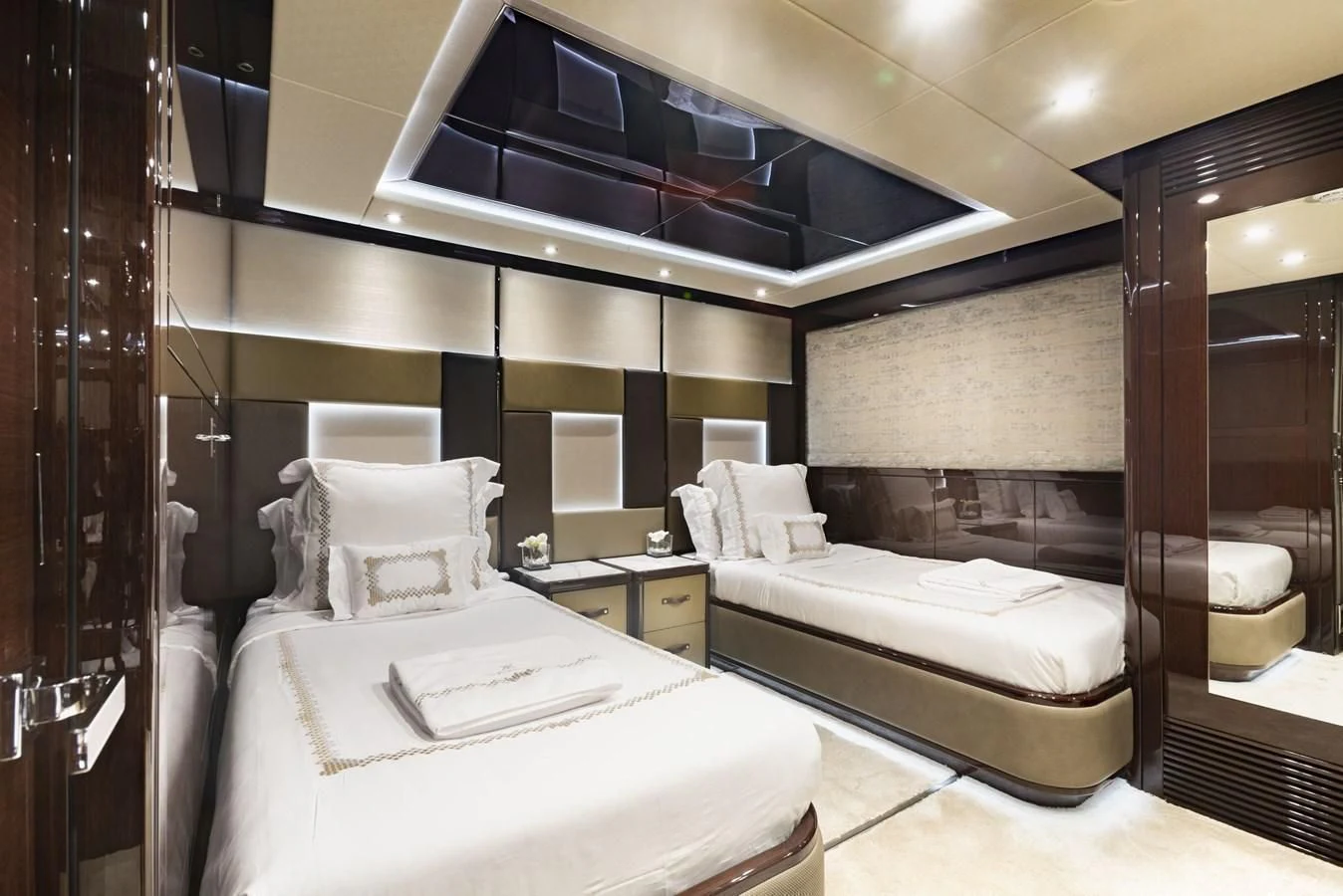 a room with a bed and a mirror aboard NEXUS Yacht for Charter