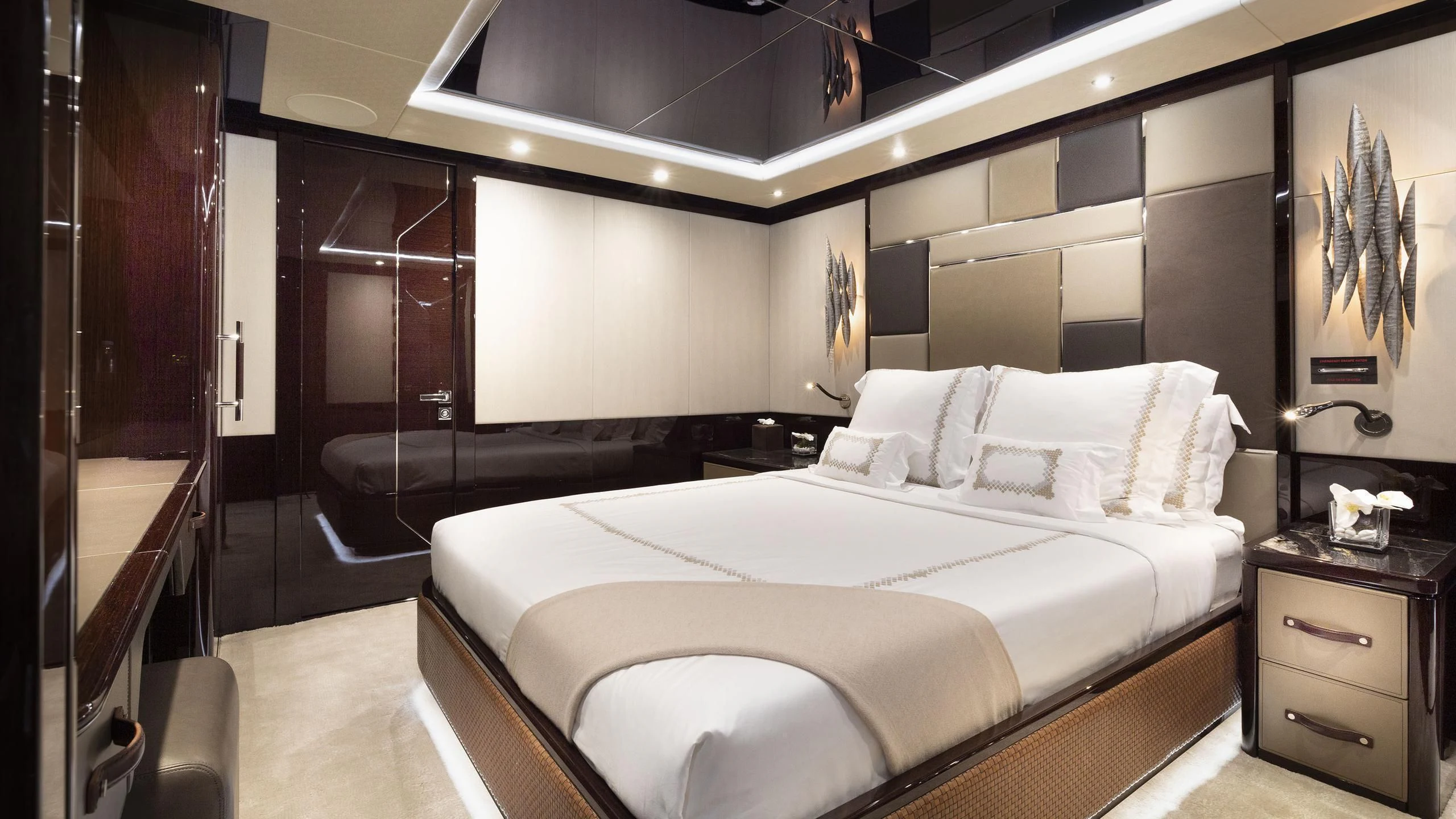 a room with a bed and a mirror aboard NEXUS Yacht for Charter