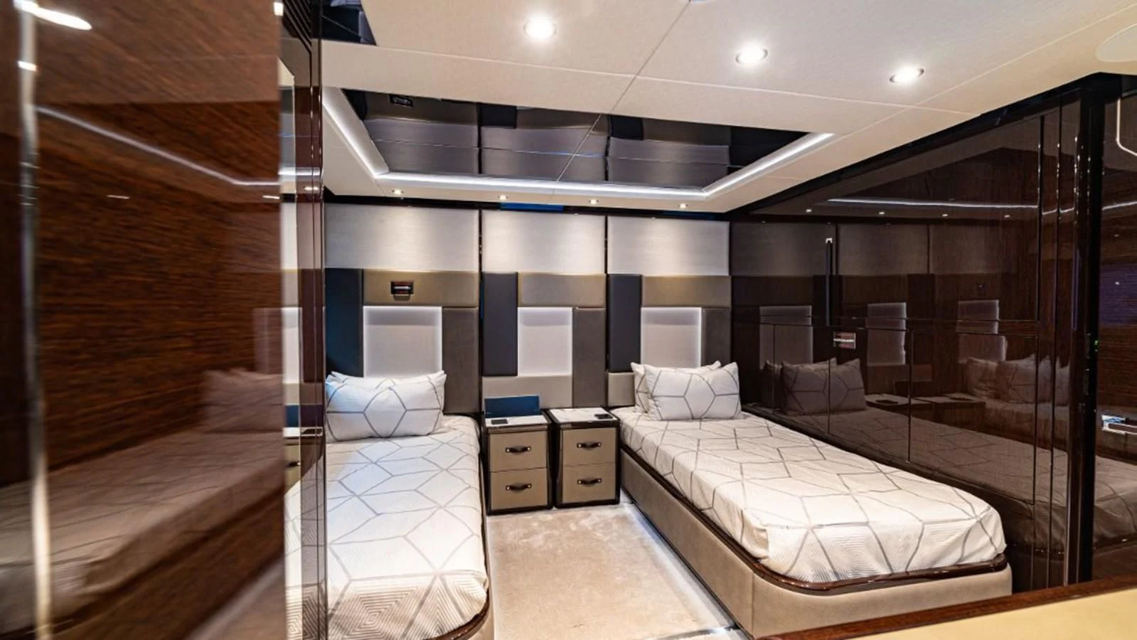 a room with a bed and a mirror aboard NEXUS Yacht for Charter