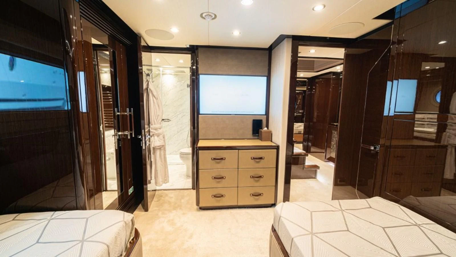 a room with a bed and a tv aboard NEXUS Yacht for Charter