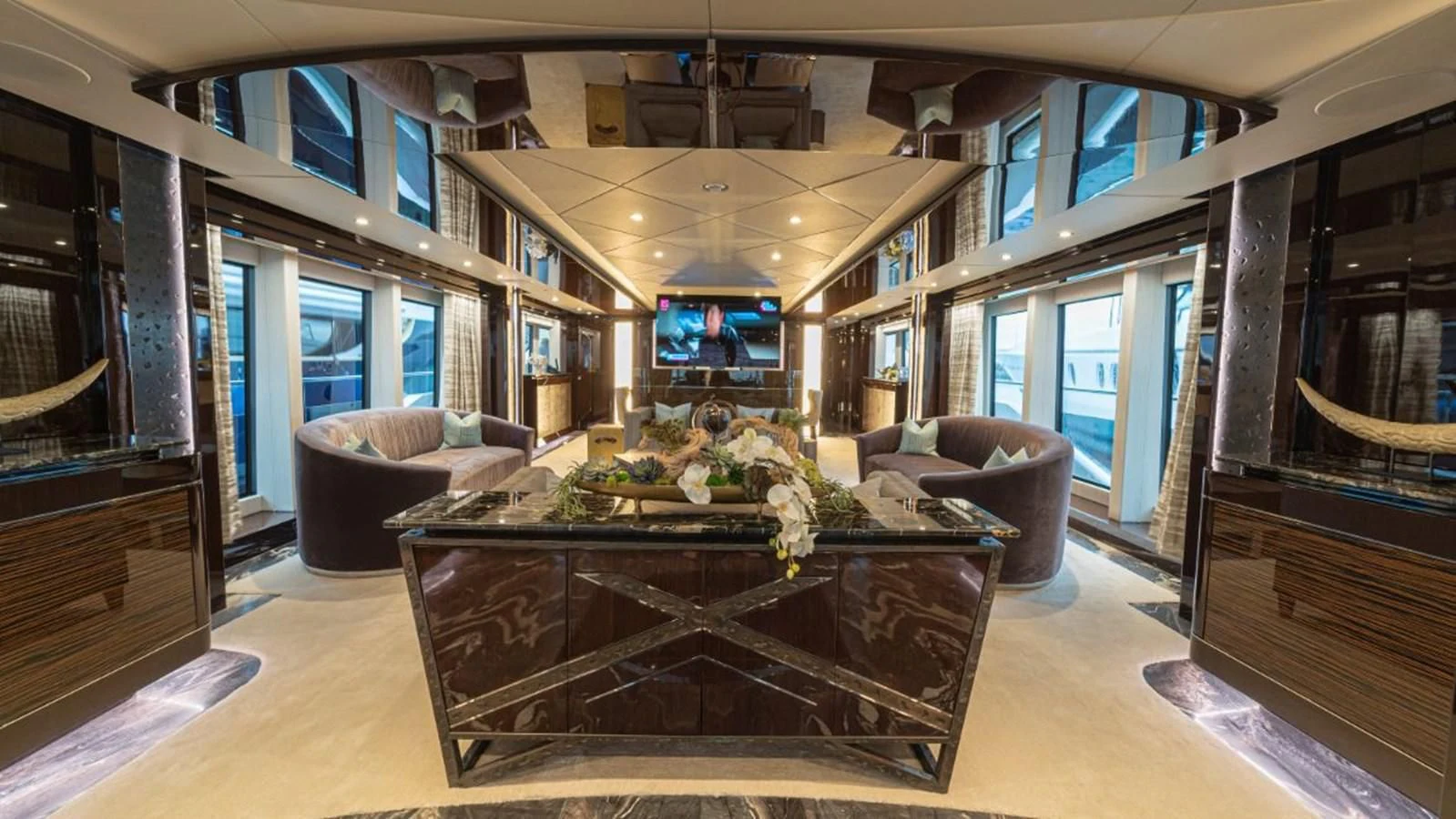 a living room with a table and chairs aboard NEXUS Yacht for Charter
