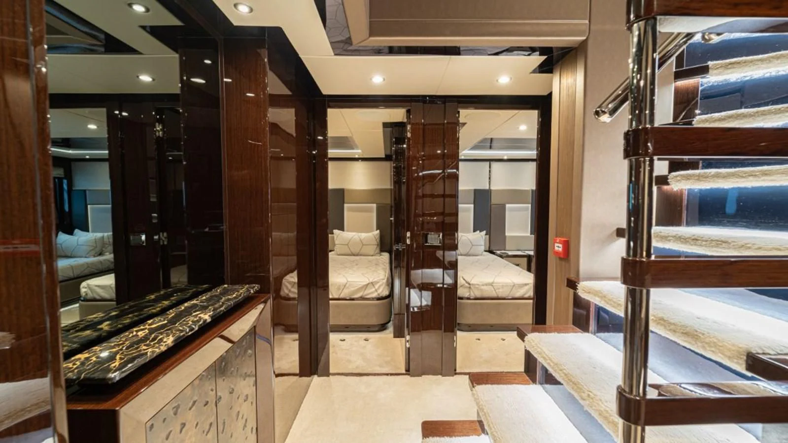 a room with a bed and a desk aboard NEXUS Yacht for Charter