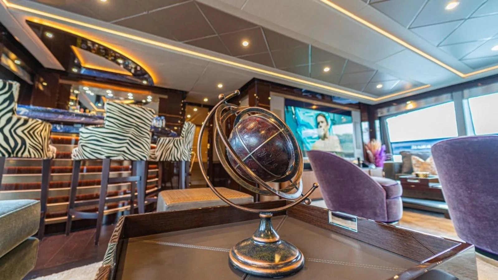 a large globe on a table aboard NEXUS Yacht for Charter