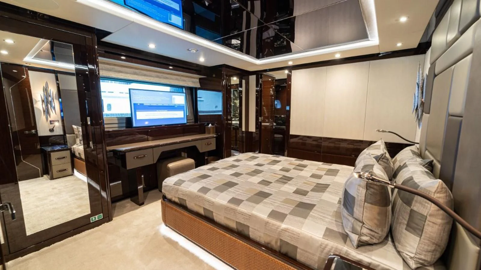 a room with a bed and a tv aboard NEXUS Yacht for Charter
