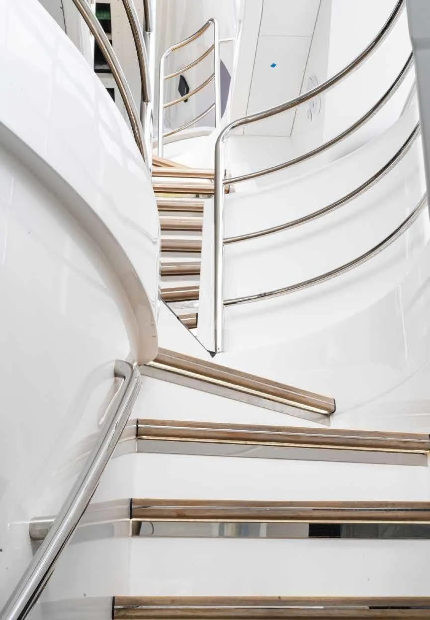 a white spiral staircase aboard NEXUS Yacht for Charter