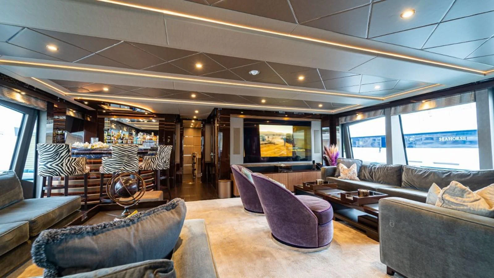 a living room with a large window aboard NEXUS Yacht for Charter