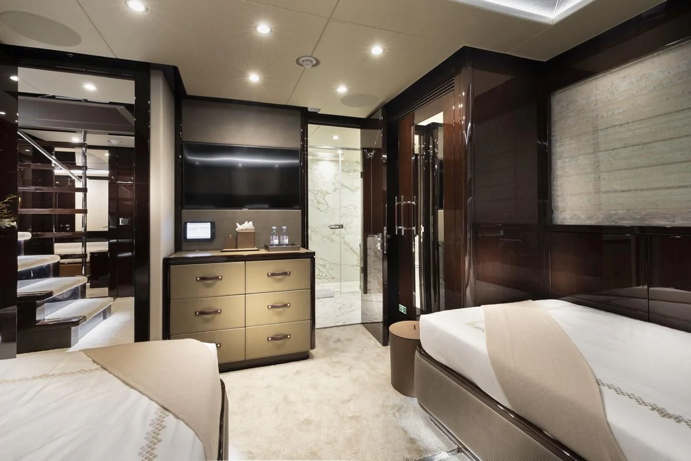 a bedroom with a bed and a television aboard NEXUS Yacht for Charter