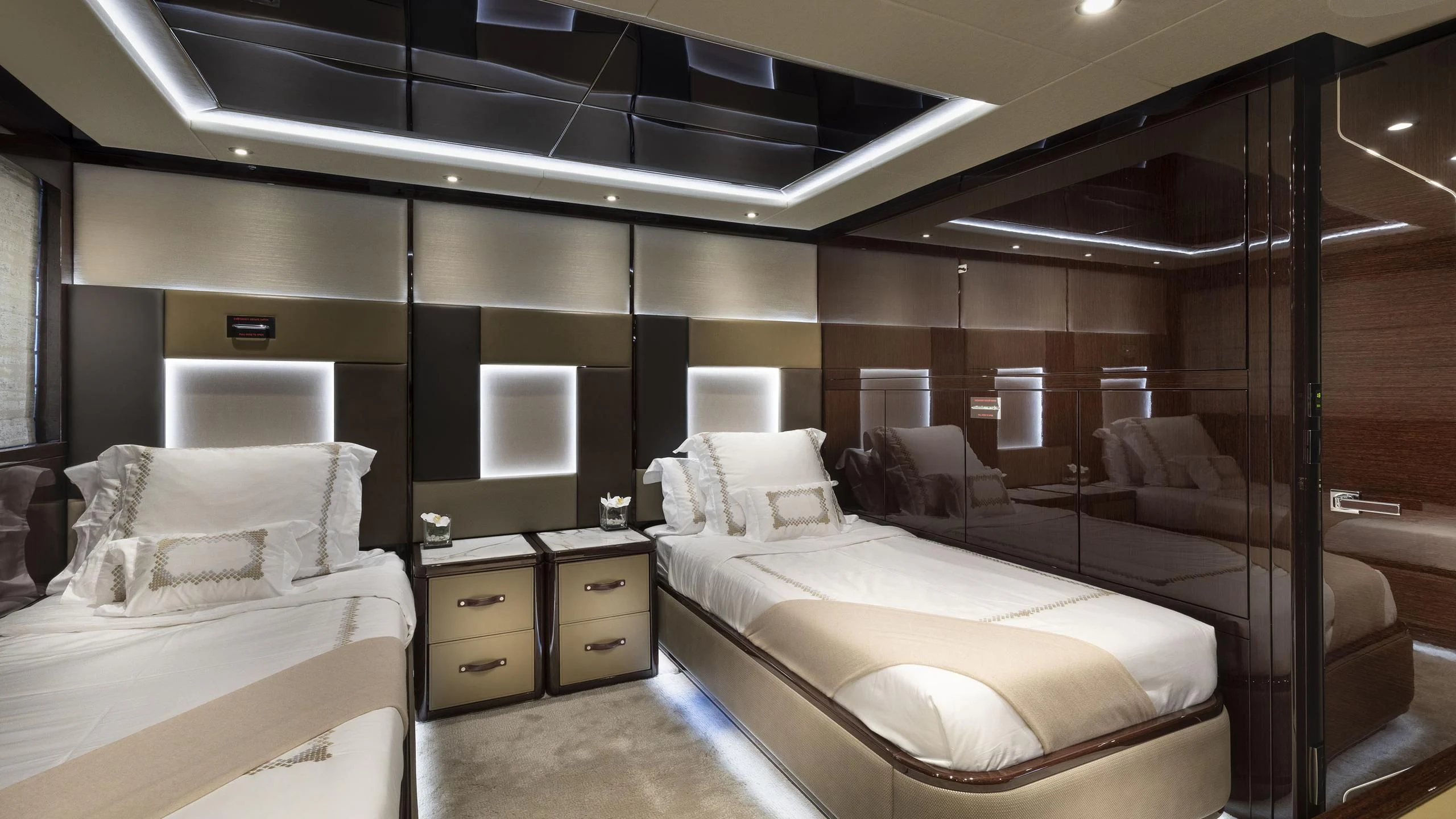 a room with a bed and a couch aboard NEXUS Yacht for Charter