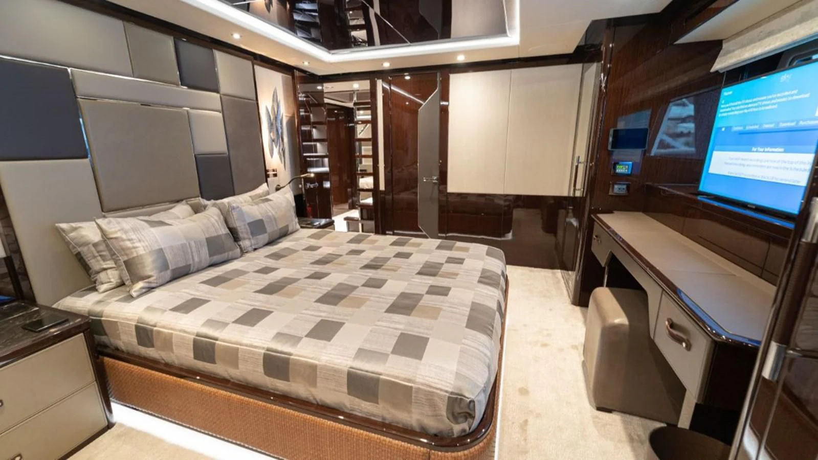 a room with a bed and a desk aboard NEXUS Yacht for Charter